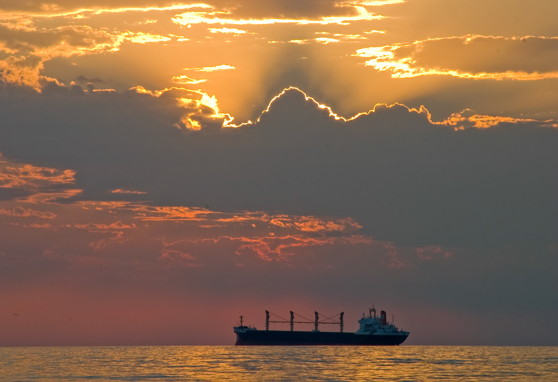 A sunrise over Lake Superior sheds light on a freighter waiting to pick up grain in Duluth.