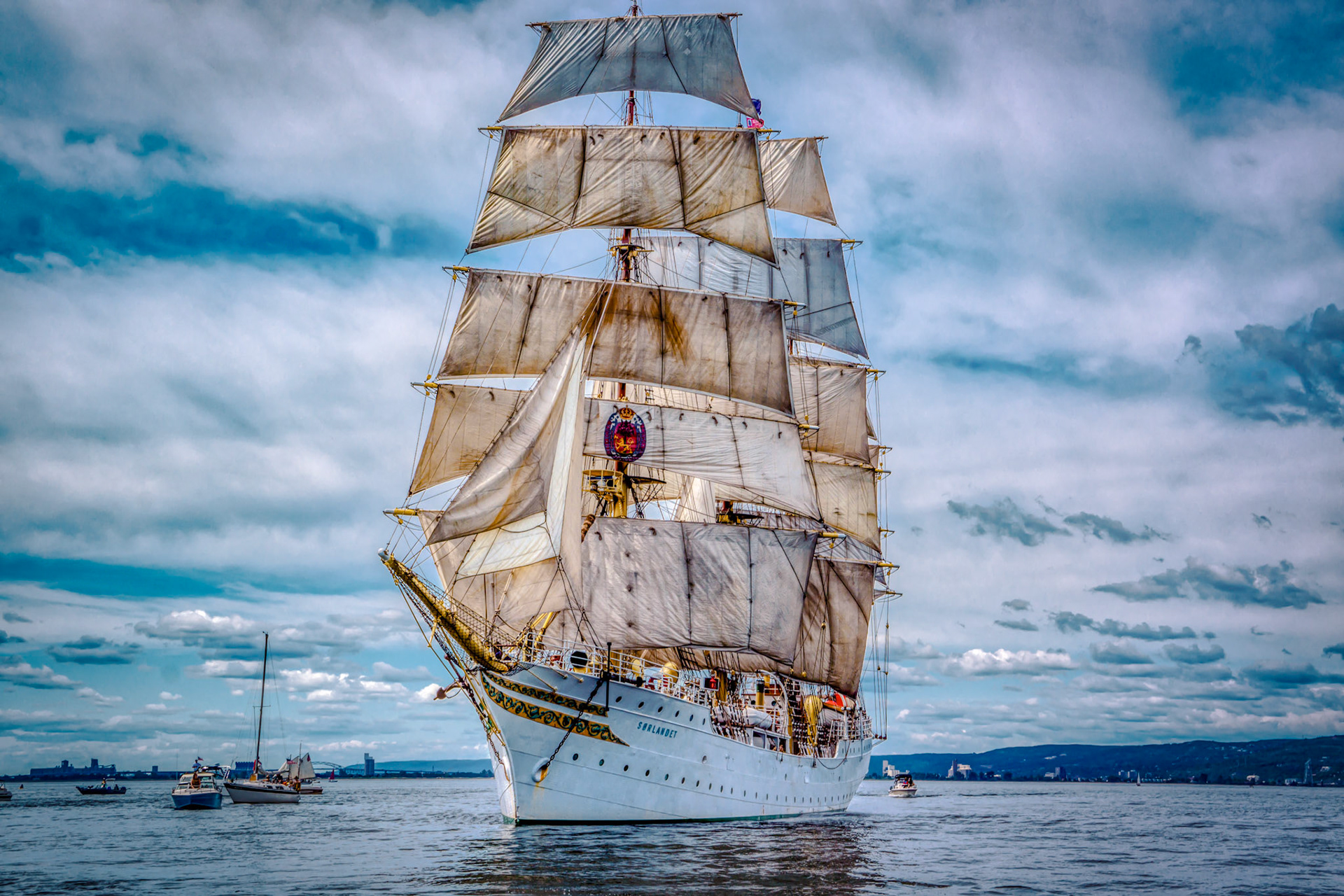 July 26—Tall Ship Sorlandet—On July 26, The Tall Ship Sorlandet spotted a full sail on Lake Superior. It is the world's oldest and most authentic fully-rigged ship still in active service. It last visited Duluth in 2013 as part of a Tall Ships Festival.With a warm breeze filling its sails, the Sorlandet embarked on a new adventure, setting sail on Lake Superior towards its next port of call. The anticipation of where this historic vessel will dock next is palpable.The wind blows to the south    and goes around to the north;around and around goes the wind    , and on its circuits, the wind returns. Ecclesiastes 1:6