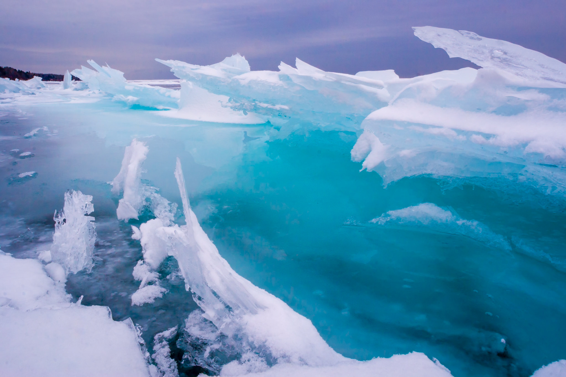 February 16 — Ice-LandIce shards continually form and shift along the North Shore of Lake Superior this time of year, creating beautiful natural art. Every night, new formations take shape, transforming the shoreline by morning.As light travels through the ice, warmer colors are absorbed, leaving behind vivid blues. Overcast skies actually enhance these tones, making the ice glow with an almost otherworldly color.I don’t know why these simple scenes are so attractive, other than that they are unusual and colorful. Sometimes the plain things are the least appreciated, yet the most valuable.“How many are your works, LORD! In wisdom you made them all; the earth is full of your creatures. There is the sea, vast and spacious, teeming with creatures beyond number— living things both large and small.” — Psalm 104:24–25The beauty of God’s creation surrounds us. All we have to do is open our eyes and see. You may feel unnoticed today, but not in God’s eyes.