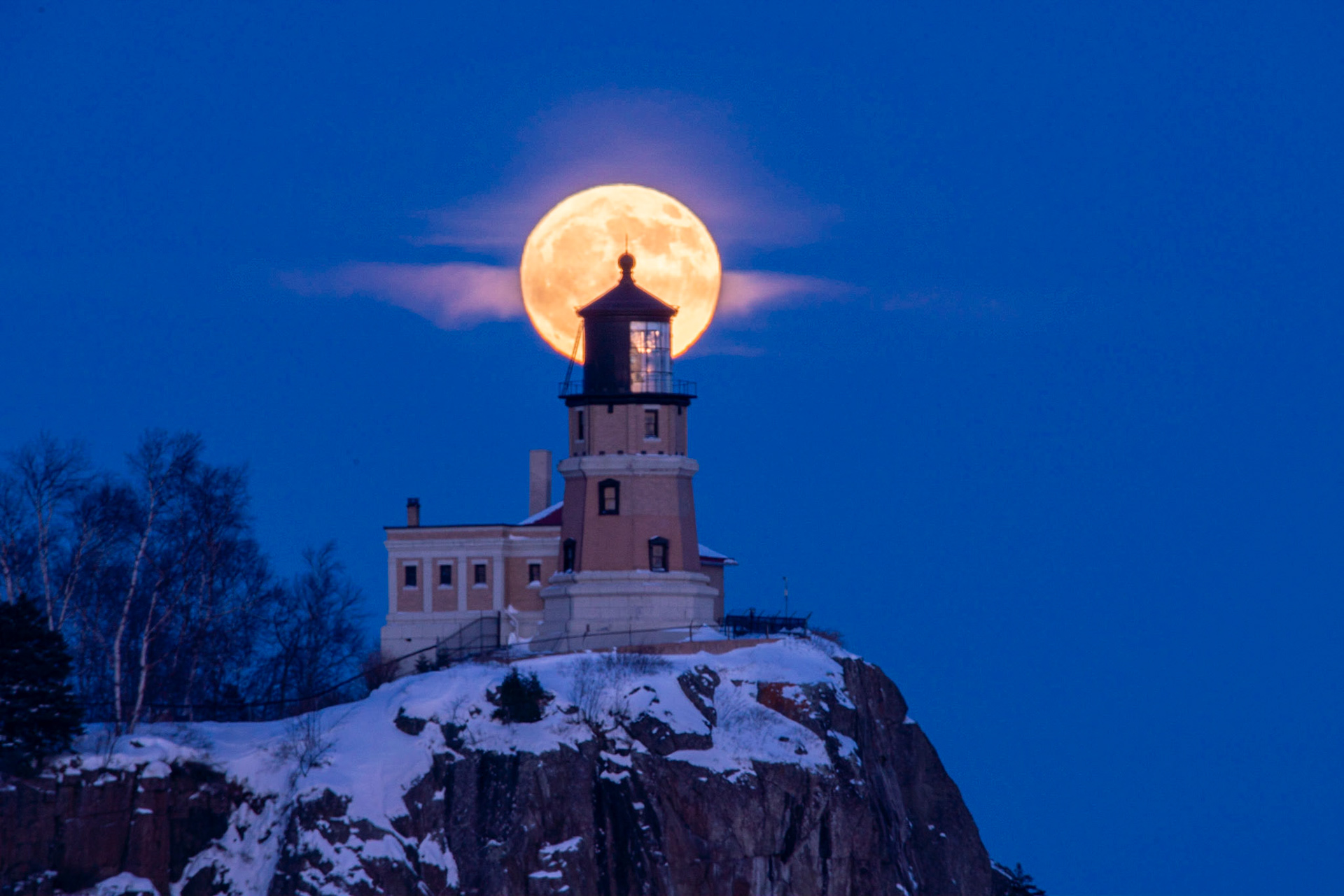 December 14th - December Full Moon at Split RockThe moon passes behind Split Rock Lighthouse as it slips into the heavens.And God made the two great lights—the greater light to rule the day and the lesser light to rule the night—and the stars. Genesis 1:16