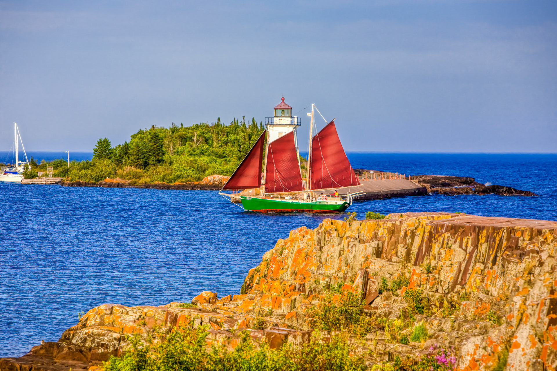 August 4 - Schooner Cruising - A cool breeze off Lake Superior blows the Schooner Hjørdis into the Grand Marais Harbor. The Hjørdis is a 1978 gaff-rigged schooner from the North House Folk School in Grand Marais, MN.The lichen-covered rocks, lighthouse, blue water, and sails bring a sense of calm to the North Shore on a perfect August evening.The Lord is my shepherd; I shall not want. He makes me lie down in green pastures.He leads me beside still waters. He restores my soul. Psalm 23