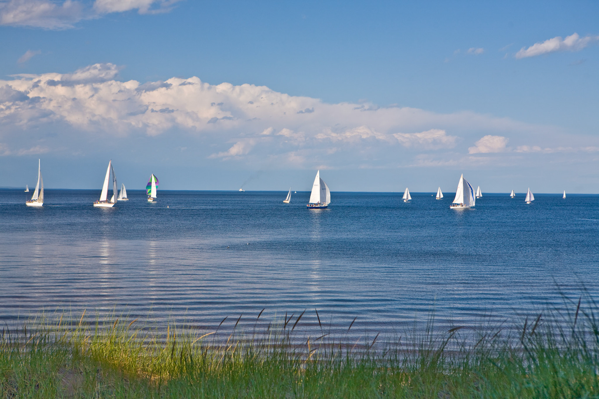 July 9 - Sails Up!  - An evening watching sailboats skimming across the clear blue waters of Lake Superior is always a relaxing and enjoyable pastime.The Bible uses wind to describe the way God works. We may not be able to see him, but there's no denying it when we're in the wake of what he's doing. Just as you cannot understand the path of the wind . . . so you cannot understand the activity of God, who does all things.—Ecclesiastes 11:5God's providence envelops us each day; what a profound reassurance to know that He is always by our side.