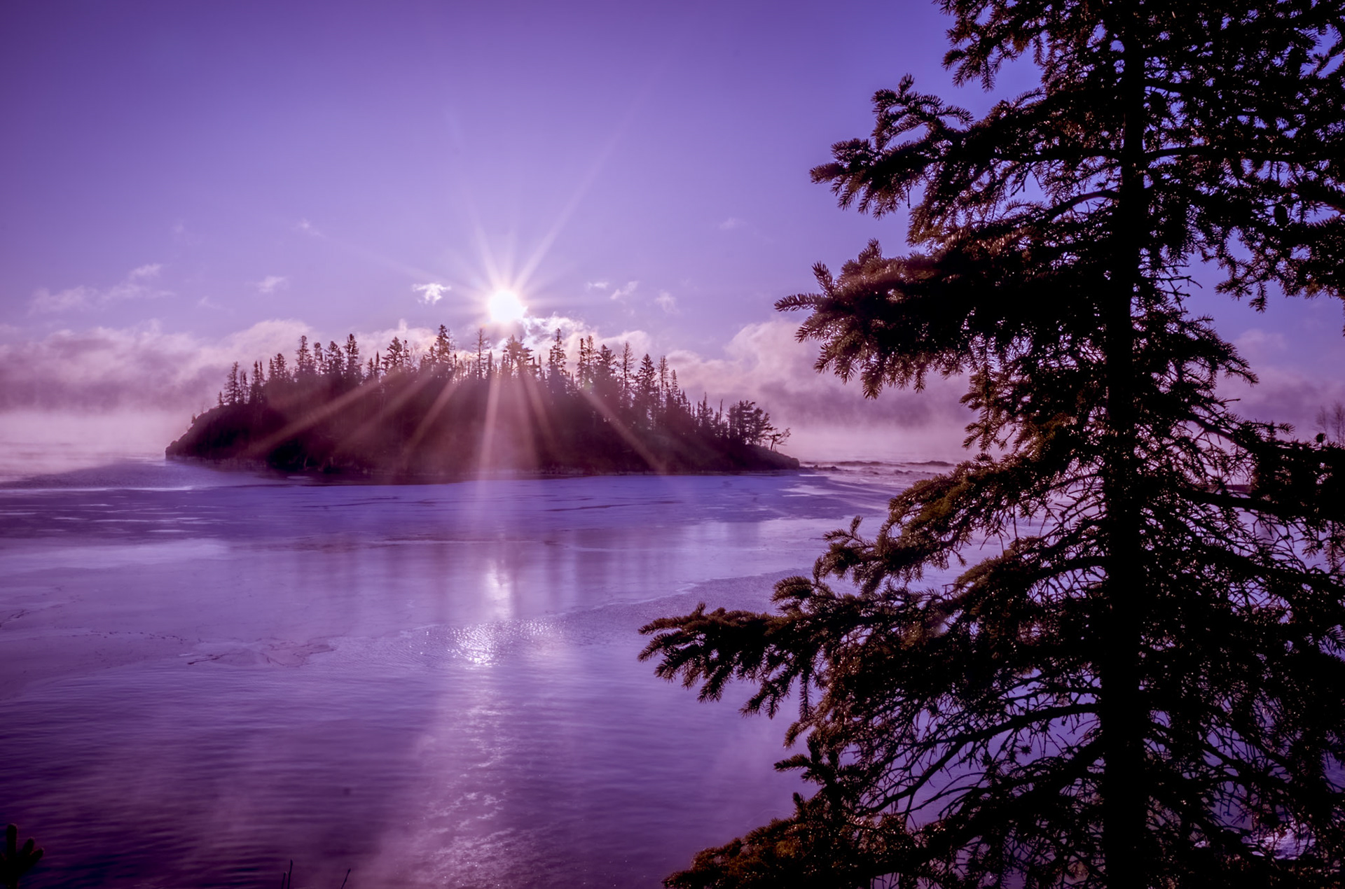 January 7th – Winter SunriseLocated near Split Rock Lighthouse, the sun rises over Ellison Island, reminding us of God's craftsmanship in everyday moments, breaking through a thin layer of winter haze and reflecting across the frozen surface of Lake Superior.Because the winter sun stays low on the horizon, its light must travel through more atmosphere. That extra distance scatters the light, revealing softer purples and pinks that only appear on the coldest mornings.Interestingly, I didn't plan on taking this picture; sometimes, photography happens. Waiting in the cold, watching the horizon, trusting that something worth seeing will eventually occur. These moments of stillness reveal God's work, much like life-He has been crafting things for our good all along; we don't notice it."And he shall be as the light of the morning, when the sun rises, even a morning without clouds." — 2 Samuel 23:4Mornings like this don't last long. The light shifts, the color fades, and the day moves on. But for a brief moment, everything slows enough to be noticed. Take a minute today to see that the God of the universe has been crafting the circumstances of your life all along, reminding us that life itself is a gift to be appreciated.