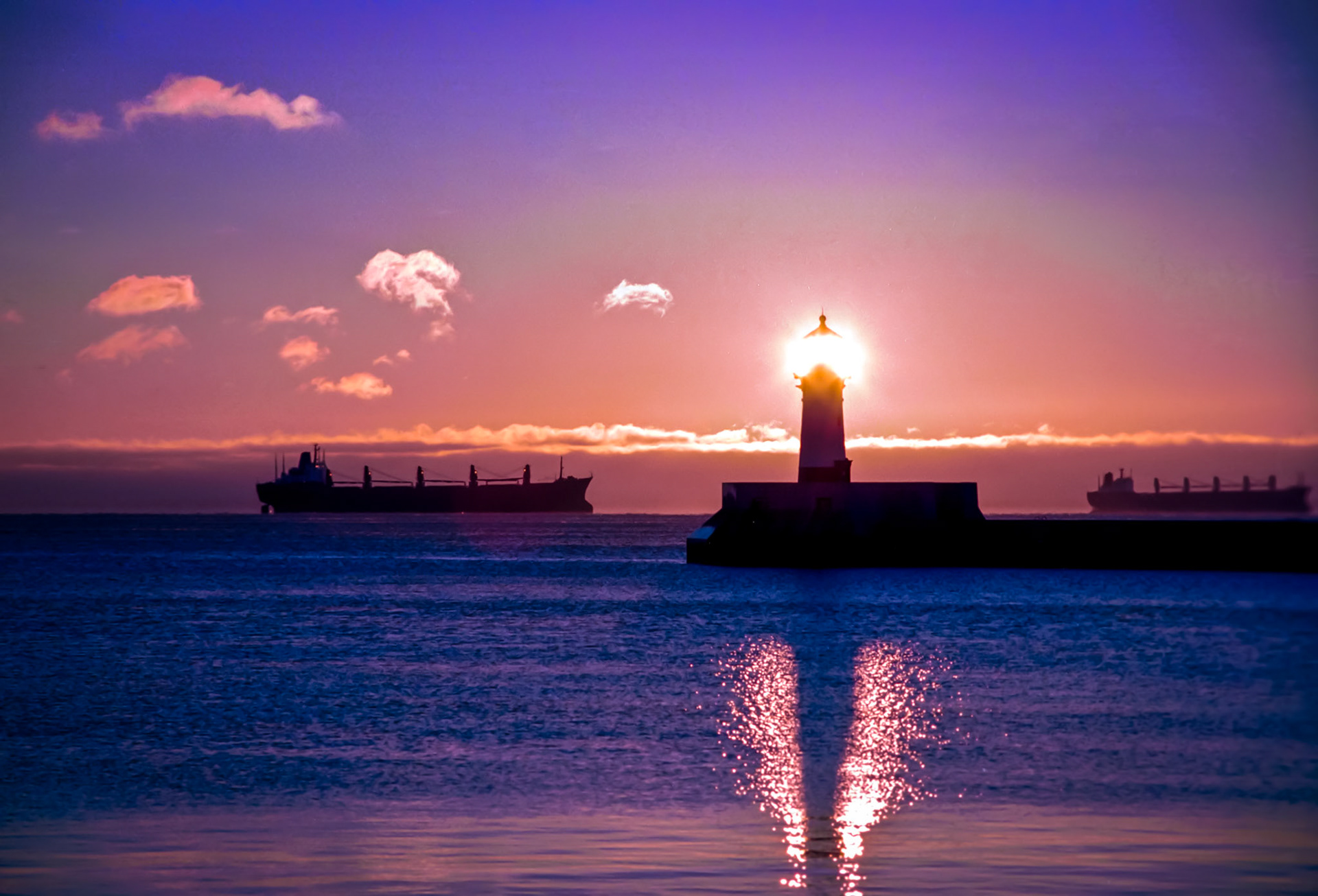 November 5 - Lighthouse Wakeup While ocean freighters wait at anchor, the sunrise quietly dawns upon the North Pier Lighthouse in Duluth.This is the day that the Lord has made; let us rejoice and be glad in it. Psalm 118:24