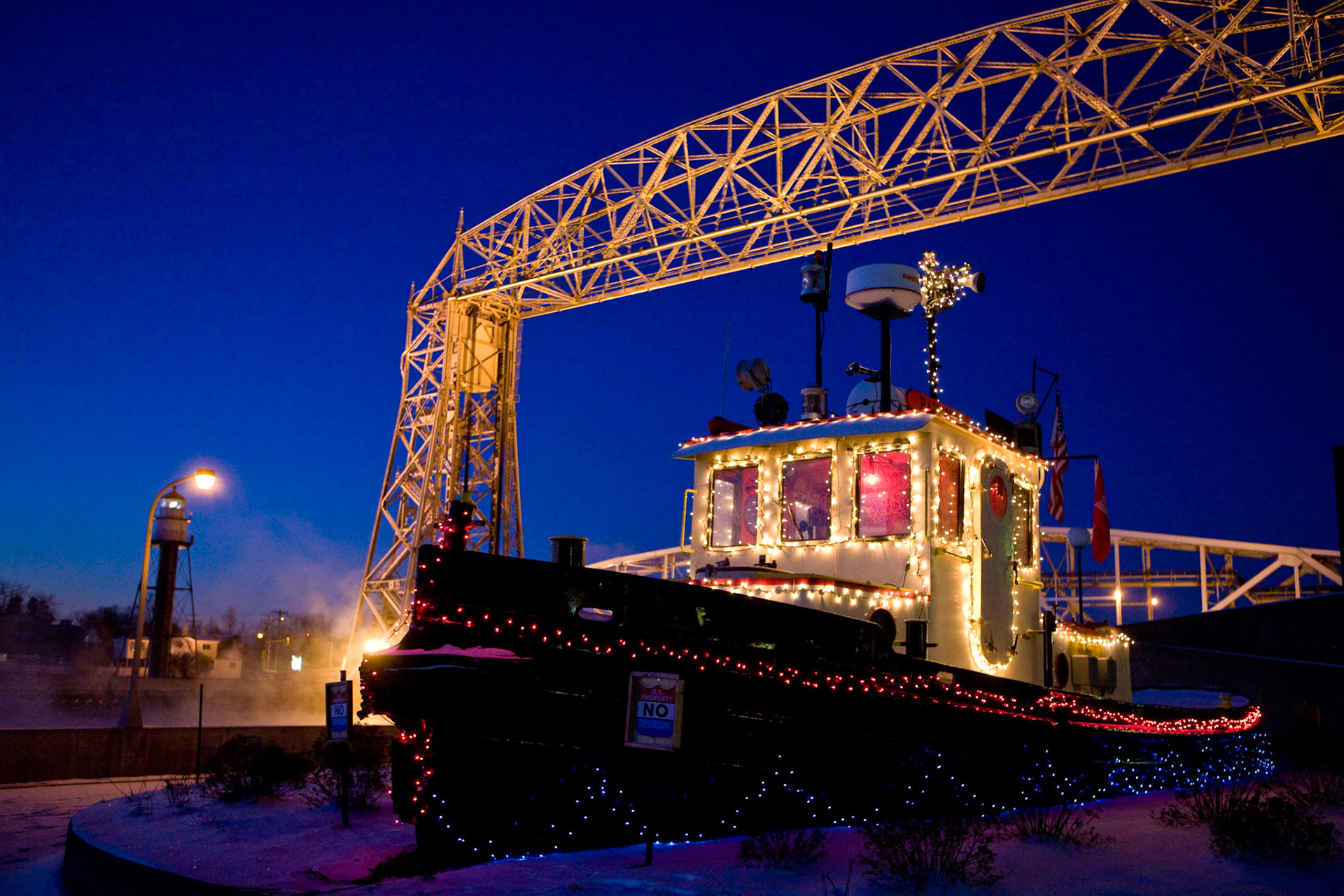 December 12th - Tug Bayfield Built-in 1953, Tug BAYFIELD did much of its work here in Duluth-Superior Harbor for the US Army Corps of Engineers. Its main job was pushing crane barges with dredging equipment mounted on deck, deck barges loaded with rock, or scows filled with dredged material.The tug, BAYFIELD, measures 45 feet long and 13 feet wide and has a 170-horsepower diesel engine. It was retired from active service in 1995 and placed on permanent display here in Canal Park in 1999.