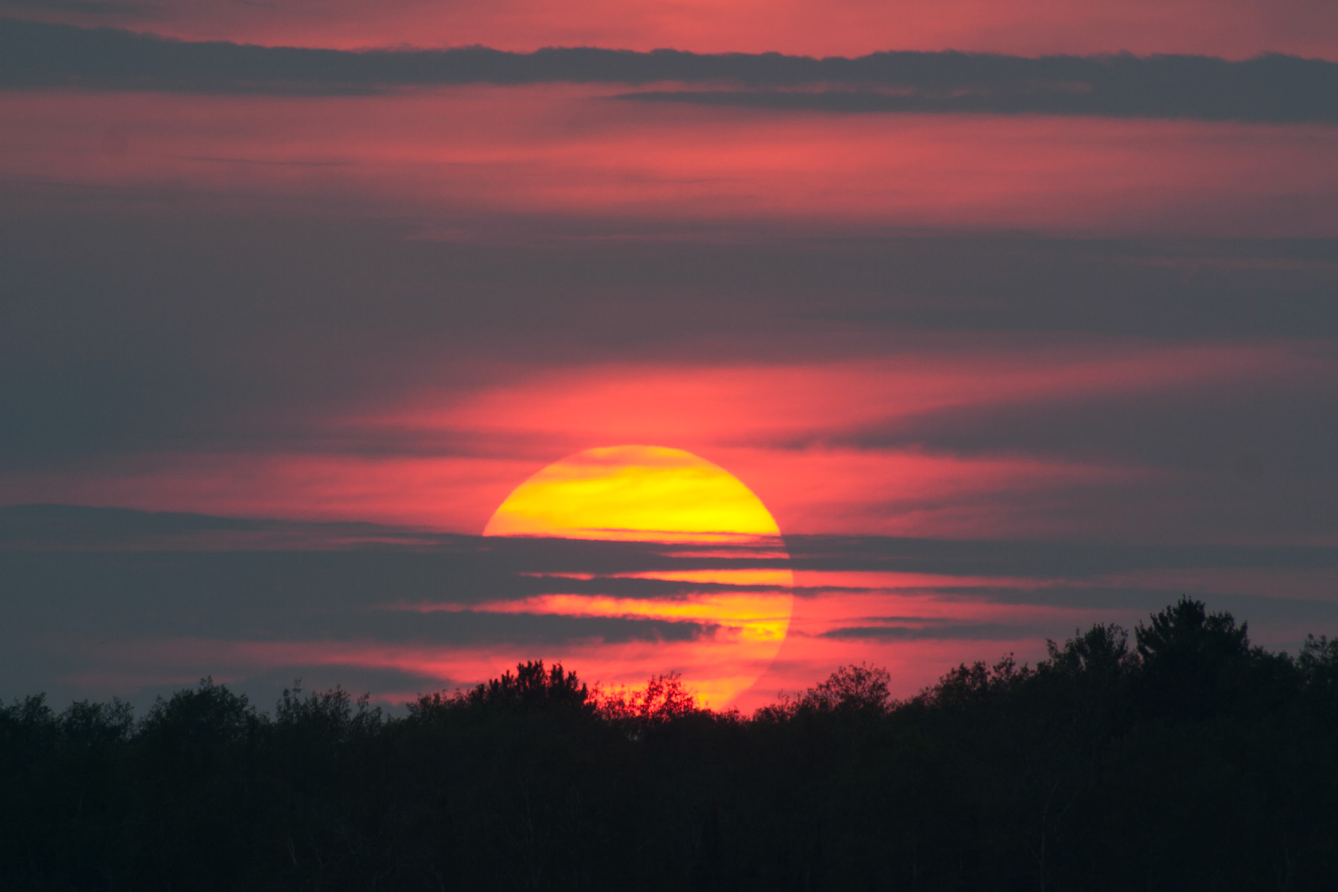 August 29 - Caribou Lake SunsetBy late August, the sun was setting earlier than in the past month, and there was a distinct sense of a change of seasons.  Here, the setting sun is veiled by the clouds as if the clouds were eyes closing an end to the day."While the earth remains, seedtime and harvest, cold and heat, summer and winter, day and night, shall not cease." - Genesis 8:22Take some time to enjoy the passing seasons; this one may be your last on this side of eternity.