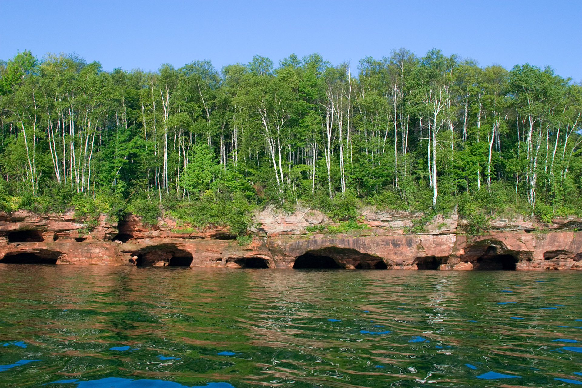 The Apostle Islands sit just off shore from the Bayfield Peninsula on Lake Superior. Erosion of the sandstone has carved out sea caves which can be visited by boat during the summer, and on skies during colder winters. The caves are one of the wonders of the region and give new meaning to "Heaven on Earth".