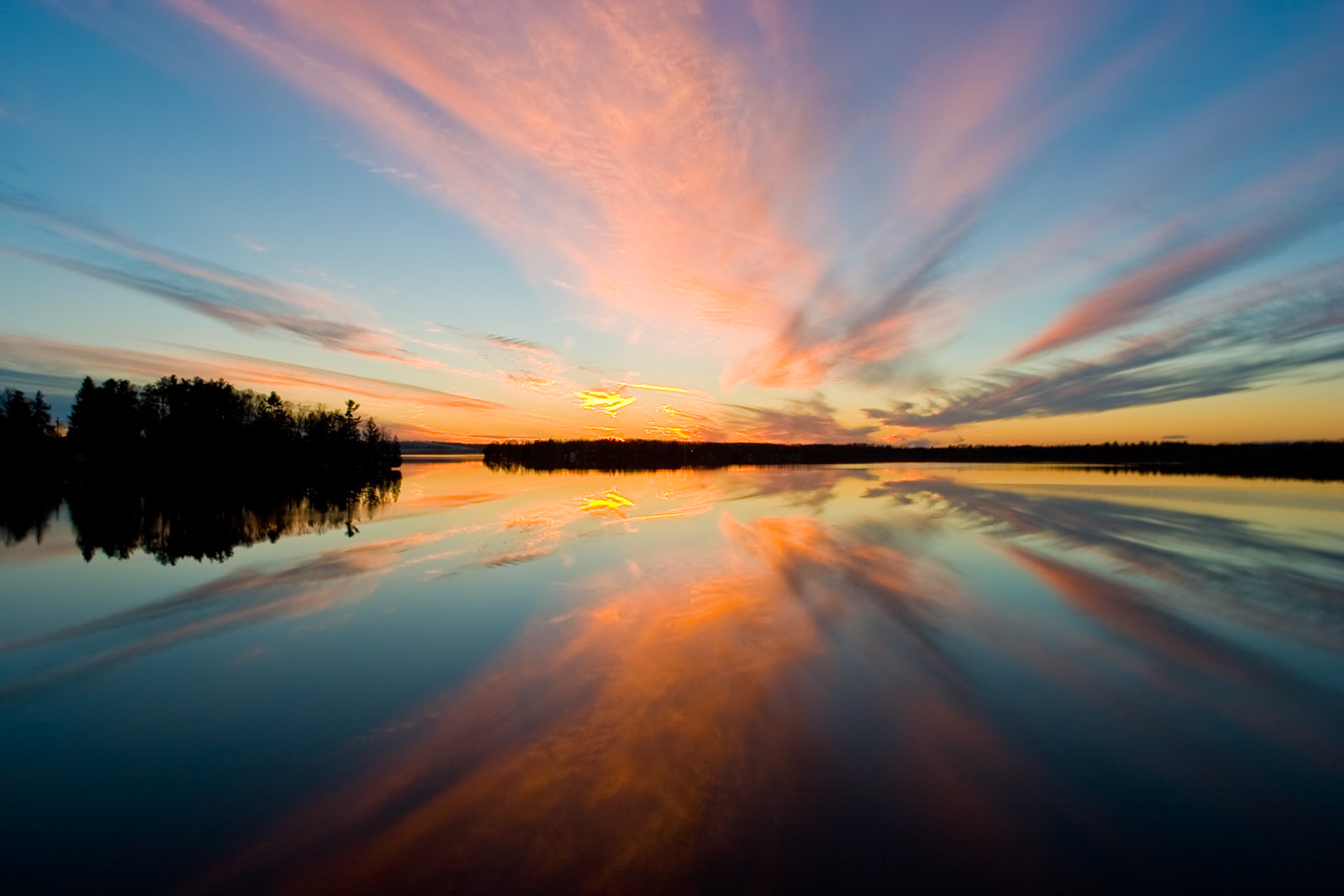 Evening clouds reflect into the waters of Caribou Lake.