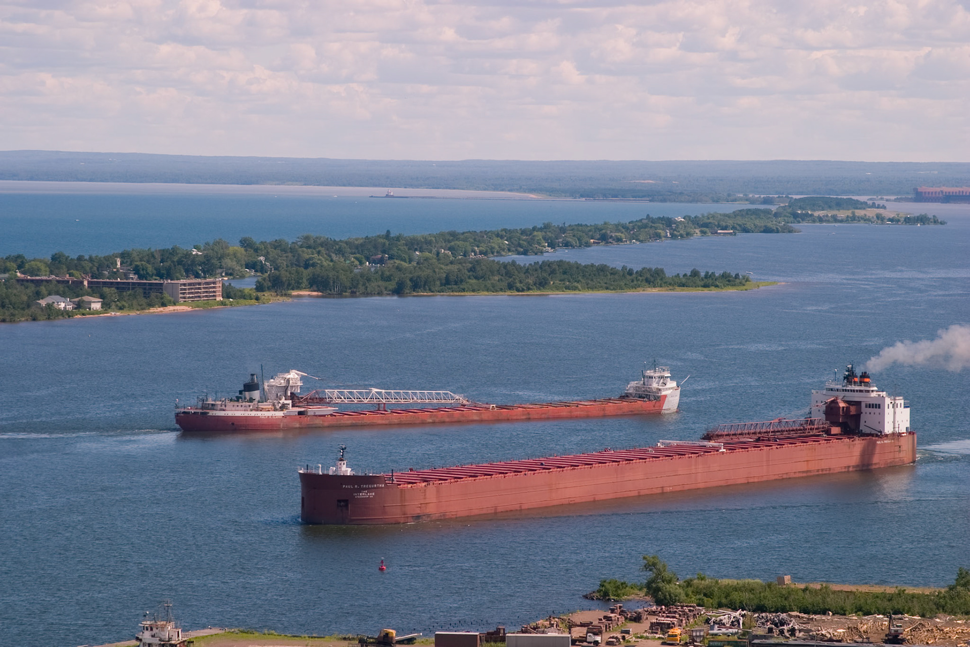 Two large ore boats squeeze past each other in the Duluth Harbor.