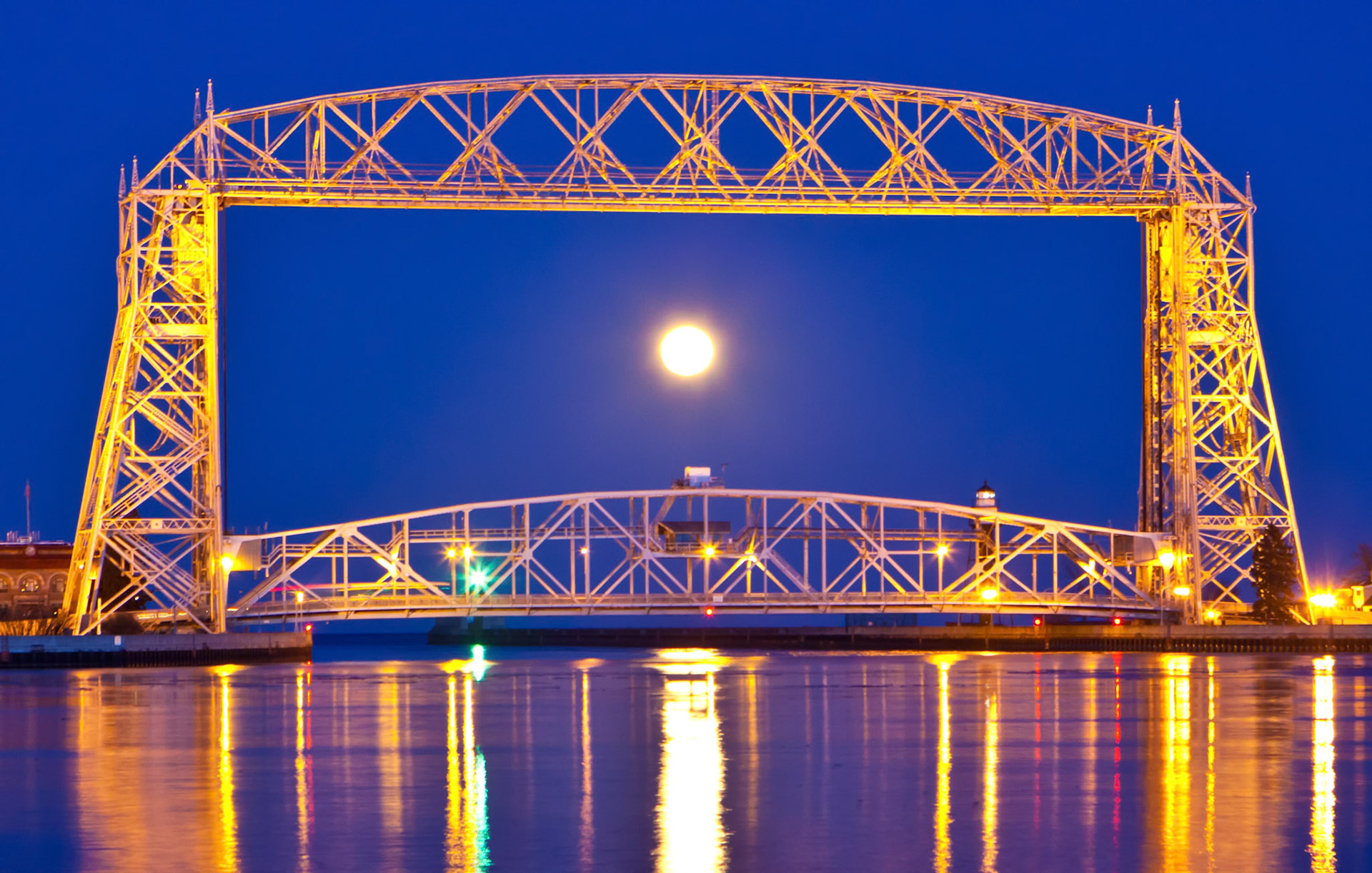 February 10 - Moonrise Through the BridgeA full moonrise is always spectacular, especially on cool February nights.The Duluth Aerial Lift Bridge, built in 1910, has spanned the shipping canal for over 100 years. This iconic bridge has fought powerful storms, blazing heat, and extreme cold, all to the tribute of its architects, builders, and operators.Similarly, we rely on the proper functioning of our world, and if we do our part as stewards of the beautiful planet, God does his part to make it pleasing to our temporary stay in this world.His master said to him, 'Well done, good and faithful servant. You have been faithful over a little; I will set you over much. Enter into the joy of your master.' Matthew 25:21 Thank you, Lord, the master craftsman of the universe, for allowing us to view its grandeur.