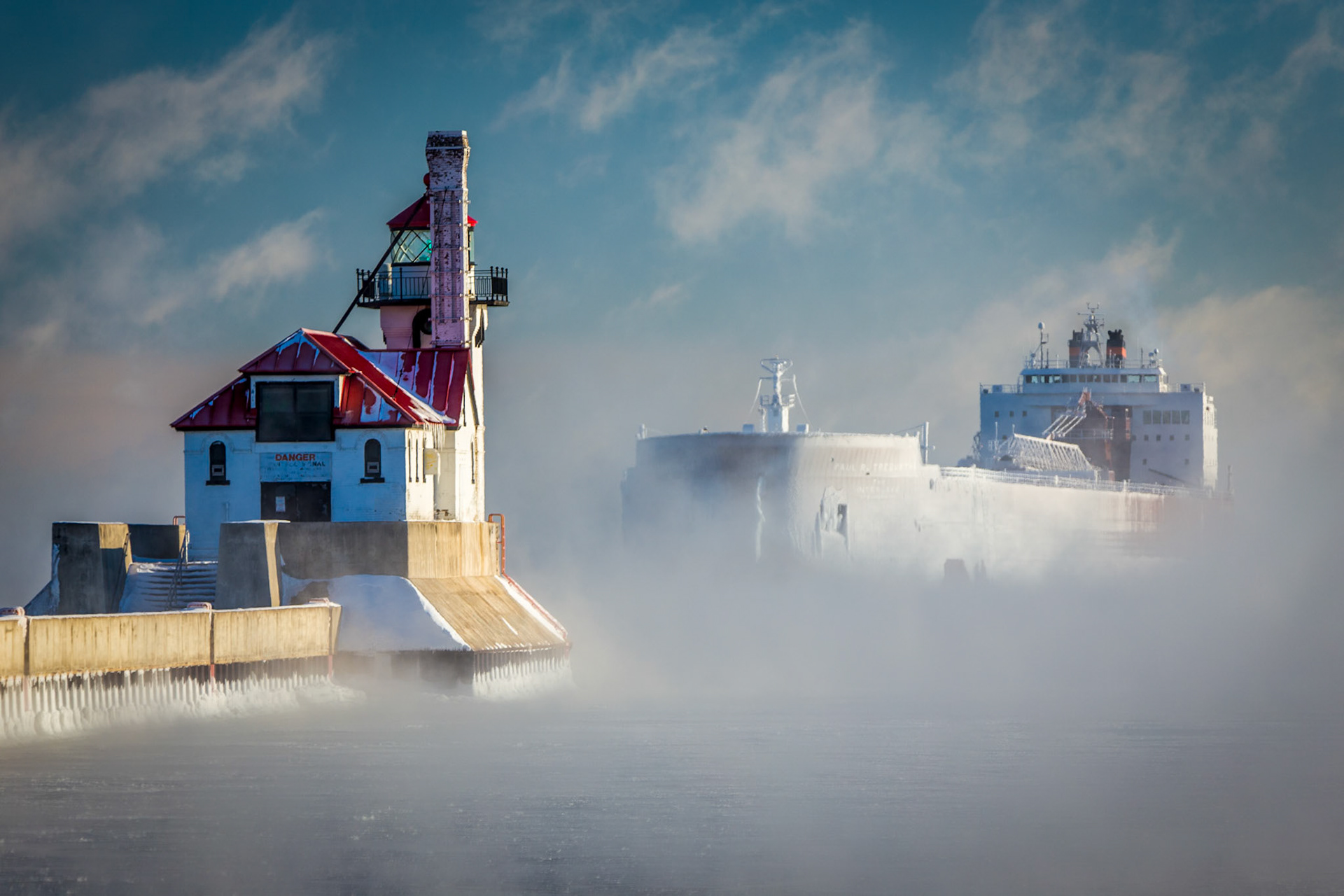 January 17 - Frozen Assets On a frigid January day, the 1000 ft Paul R Tregurtha entered the Duluth Shipping Canal loaded with ice from its frigid trip across Lake Superior.As the Great Lakes shipping season ends mid-January, lakers struggle through extreme weather as the grip of a powerful cold front holds tight.Water appears here in all three of its physical states: liquid, vapor, and ice—a perfect scene for winter photography. Come to me, all who labor and are heavily laden, and I will give you rest. Matthew 11:28A quiet scene of peace and beauty. We all need rest at some point, both physically and spiritually. So, take a few minutes today to reflect on where you are and where you are going! God knows your situation and offers rest beyond measure.