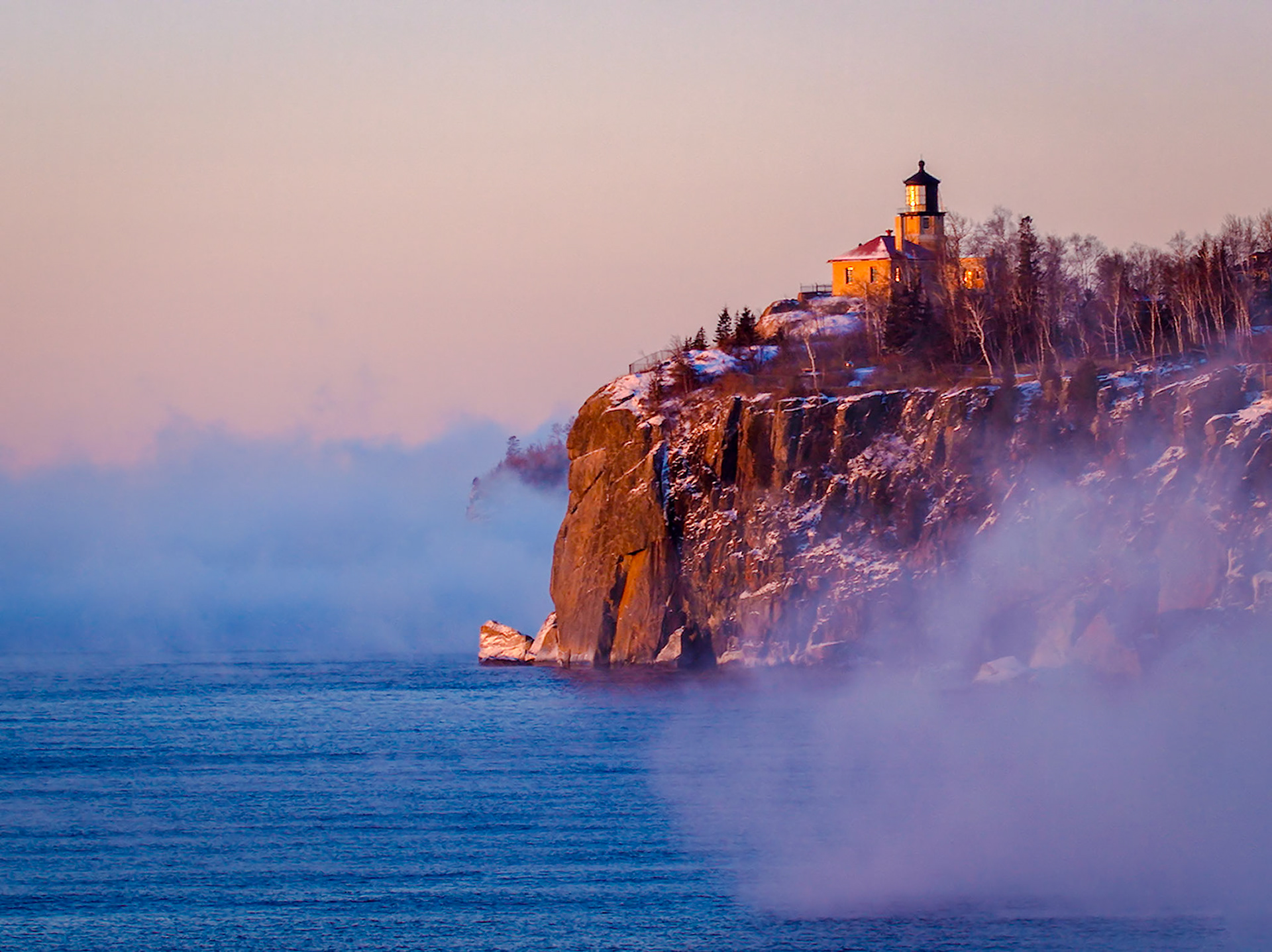 March 9 — Ice MistAn icy mist rises off Lake Superior on this –20°F morning in March. Even for Northern Minnesota, temperatures this cold so late in the season are unusual. Yet it is often extremes that draw hidden beauty to the surface, as vapor lifts gently from the dark waters below Split Rock Lighthouse.But the mist is temporary. As sunlight strengthens and the air begins to warm, the delicate balance shifts. Droplets evaporate, crystals vanish, and what once filled the air becomes invisible again. What appears solid and dramatic is, in reality, fragile — existing only within a narrow window of cold.As you view this scene, it is easy to see the seasons' interplay, as winter slowly yields to spring in their quiet, ongoing struggle.“You are a mist that appears for a little while and then vanishes.” — James 4:14Like this icy vapor rising from Lake Superior, our days appear briefly and then drift away. Yet even in our brevity, God offers His love, patience, and mercy to all who turn toward the Light of the World — Jesus Christ.