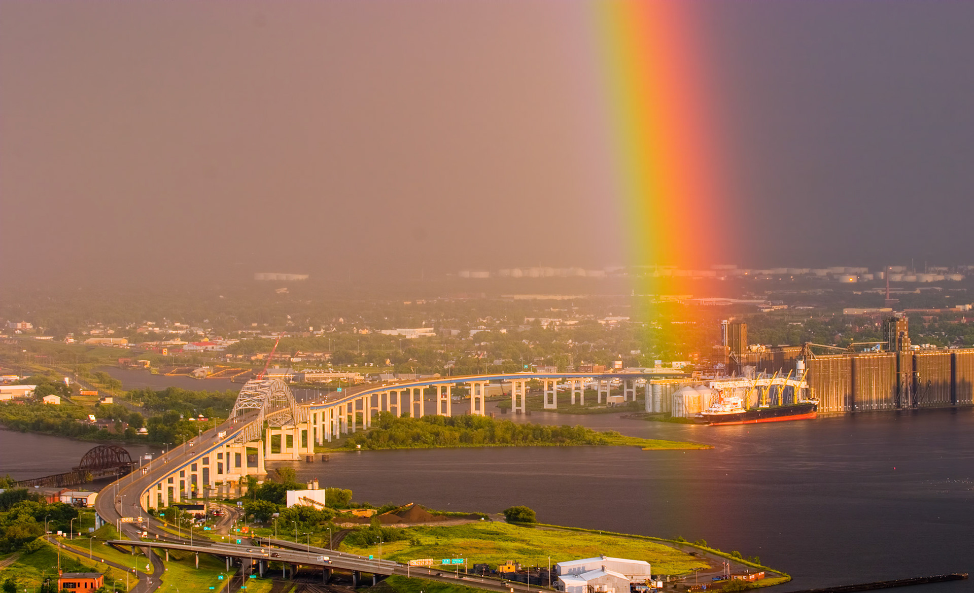 July 25 - Pot of Gold - After a passing thunderstorm, a rainbow highlights a loading grain ship in Superior, Wisconsin.Rainbows remind us that even after life's storms, a beautiful and hopeful tomorrow is always waiting for us. "But the Lord is faithful; he will strengthen you and guard you from the evil one. And we are confident in the Lord that you are doing and will continue to do the things we commanded you." 2 Thessalonians 3:3-4Make this the start of a beautiful day by thanking God for His promise of hope in a simple rainbow.