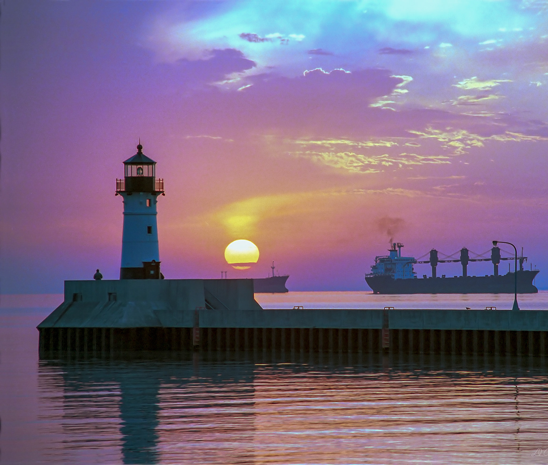 October 23 - Dawn Early LightFreighters lay at anchor waiting for their turn to load grain in Duluth as a late October sunrise spreads warmth over Lake Superior.The vivid colors of the sunrise and the sounds of the water and seagulls are a sure way to start the day.It is incredible how God can mix the elements to create a scene like this.Yours is the day and the night; you have established the heavenly lights and the sun. Psalm 74:16
