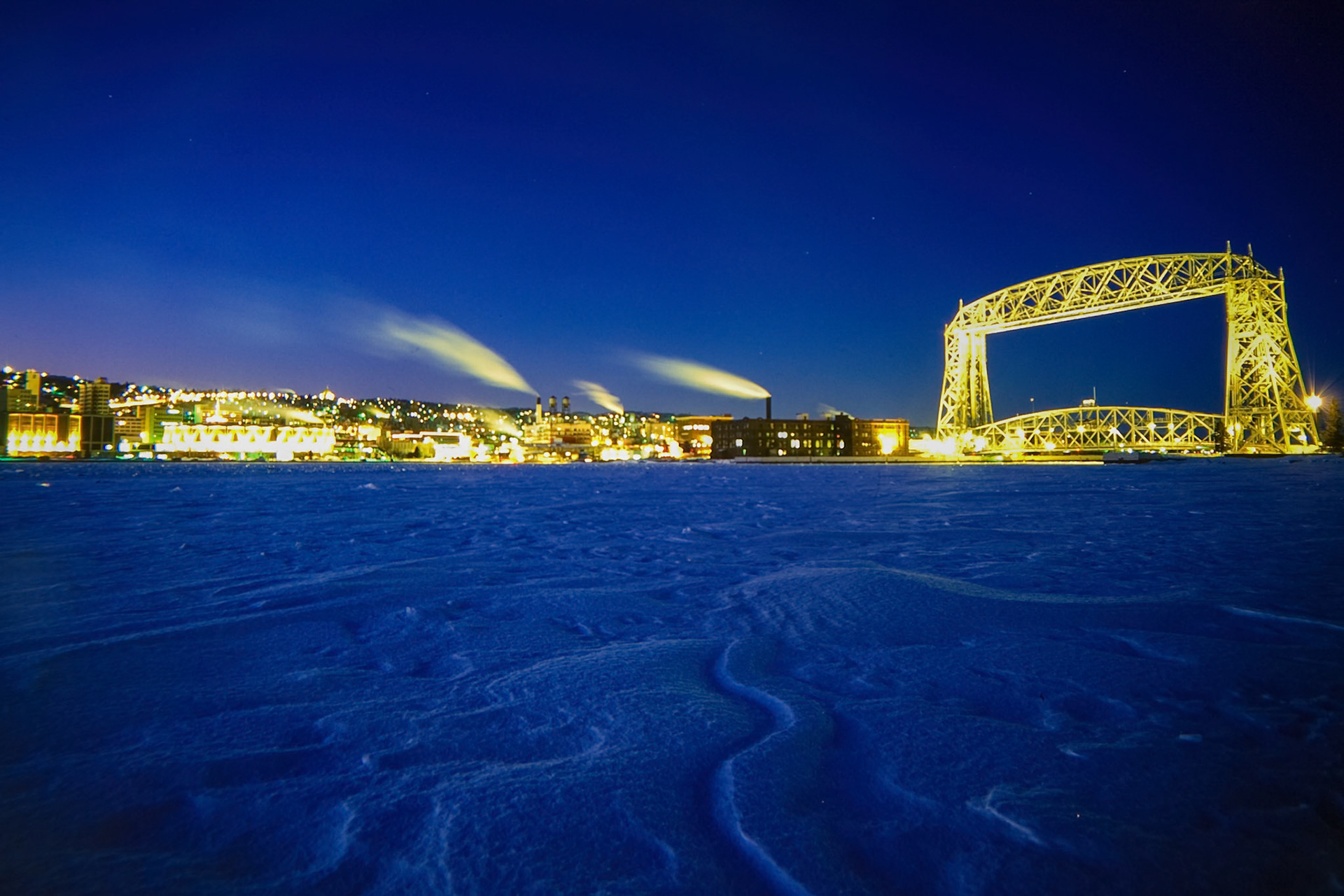 The Duluth Aerial Lift Bridge, built in 1905 was originally a transfer bridge using a gondola type carriage to move cars, people, and horses between Park Point and Downtown Duluth.