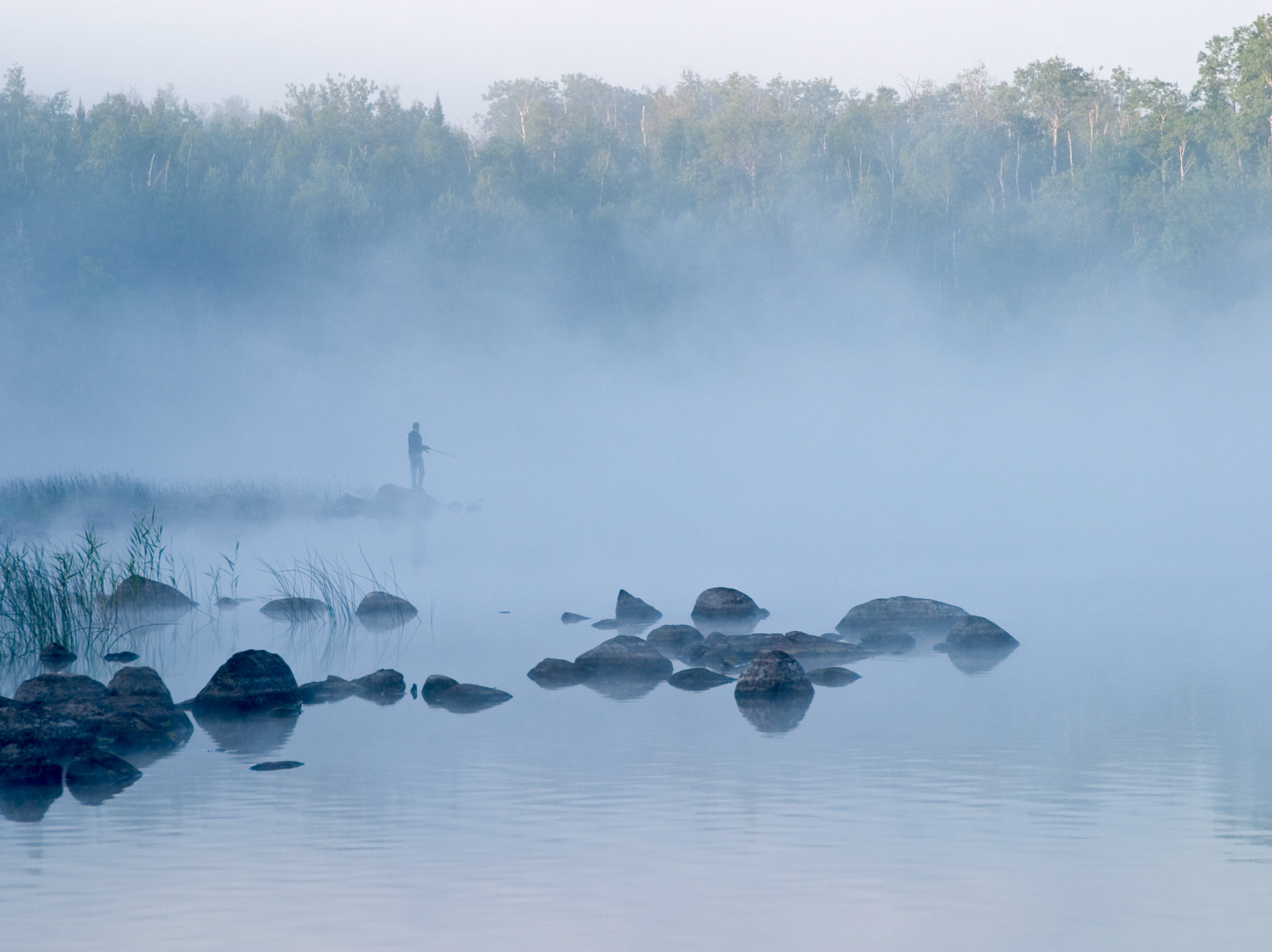 July 24 - Peaceful Morning Fishing - A lone fisherman casts into the waters of a lake in the Boundary Waters Canoe Area.On this serene July 24 morning, a solitary fisherman gently casts his line into the tranquil waters of a lake in the Boundary Waters Canoe Area. The cool mist of morning rises, embracing the fisherman and the surroundings with a serene calm. The beauty of God's creation, in its quiet majesty, soothes our souls and reflects His Glory."Now may the Lord of peace himself give you peace at all times and in every way. The Lord be with you all." - 2 Thessalonians 3:16mist of morning rises peacefully from the lake to envelope the fisherman and surrounds him with calm serenity.God's creation settles our soul and reflects His Glory.May the Lord of Peace always give you peace in every way. The Lord be with you all. 2 Thessalonians 3:16 May we always find peace and tranquility in the beauty of nature and the grace of God.