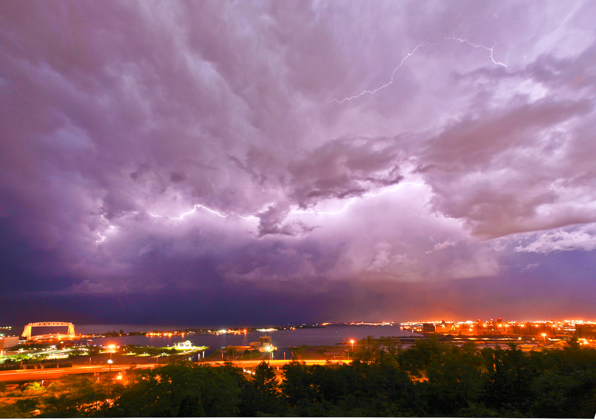 July 10—Storm Front Over Duluth—Duluth's average high temperature in July of 75F provides plenty of fuel for thunderstorms. It is always enjoyable to try your luck at capturing lightning with your camera.The temperature of a lightning bolt can reach a staggering 50,000 °F – significantly hotter than the sun's surface, which is only about 10,000. This immense heat causes the air around the bolt to expand rapidly, breaking the sound barrier and creating the awe-inspiring clap of thunder.Behold, he scatters his lightning about him and covers the roots of the sea. Job 36:30The power of lightning is infinitesimally small compared to the power of our God.