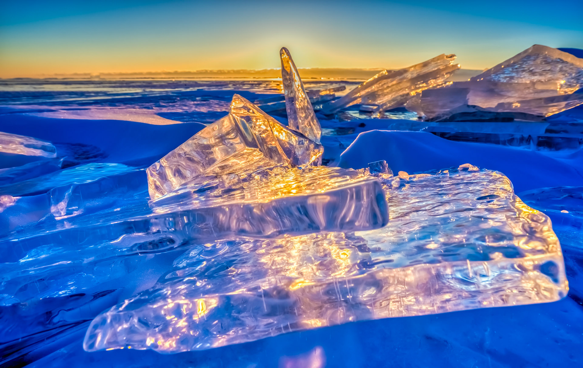 February 26 - Crystal ShoresGleaming in the rising sun, stacks of sheet ice decorate the shoreline of Lake Superior. Late February is prime time for ice photography along the North Shore, as strengthening sunlight and growing wave action break the shore ice apart.Lake Superior’s ultra-clear water freezes into remarkably transparent ice, enhancing refraction and creating glass-like clarity with glowing edges and vivid blue-and-gold highlights.A simple walk along the shore calms the soul and reminds us of our daily blessings.“Having the glory of God, its radiance like a rare jewel, like jasper, clear as crystal.” — Revelation 21:11God’s creation surrounds us in every season. As February fades, winter loosens its grip, and a new season draws near.
