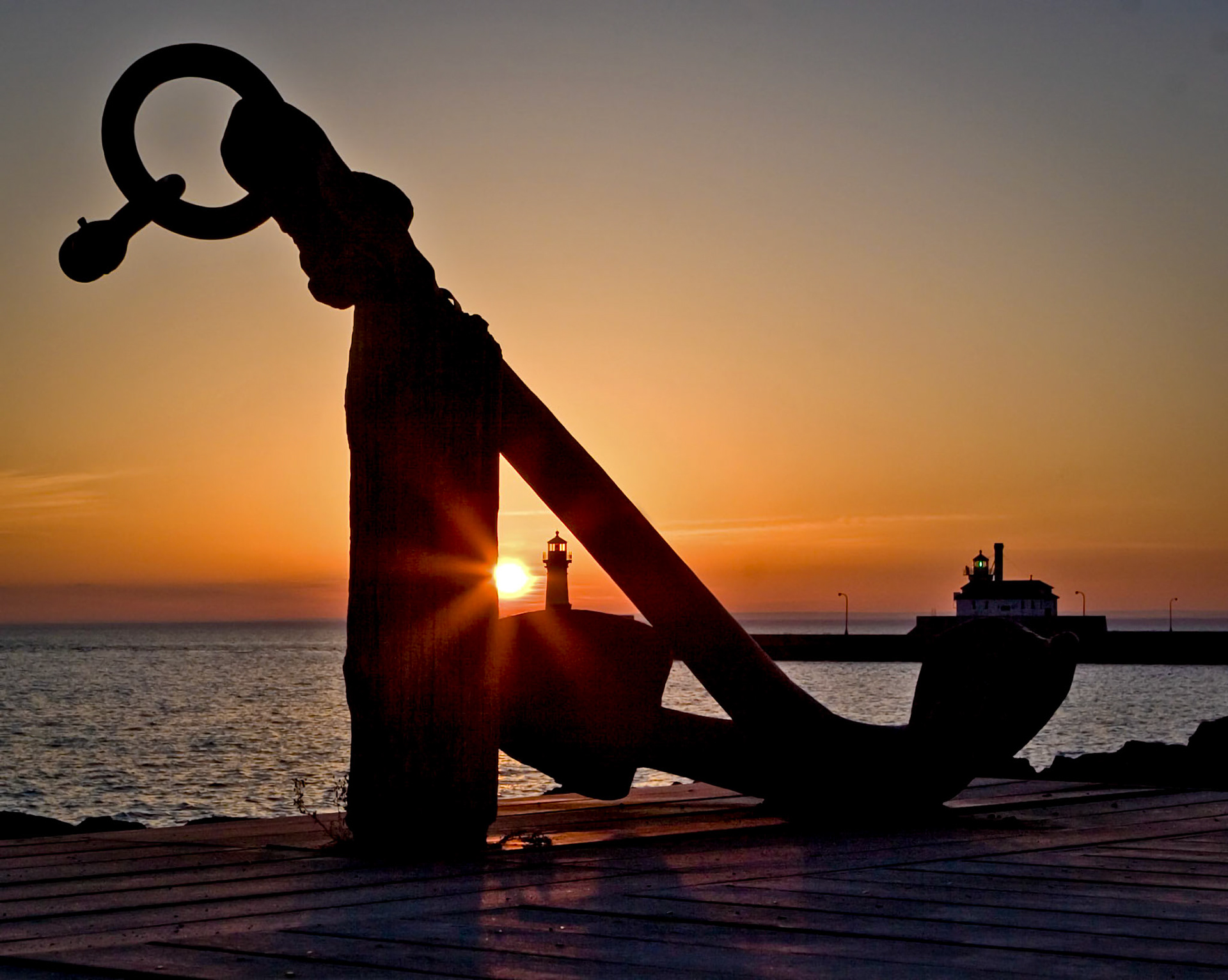 Cool fresh air off Lake Superior and the glow of first light on this January morning brings thoughts of soon coming springtime and of thankfulness to God for making the day and allowing me to enjoy it. One of the ancient ship anchors that decorate the Duluth Lakewalk helps frame the Canal Park Lighthouses in this scene.This is the day that the Lord has made; let us rejoice and be glad in it. Psalm 118:24