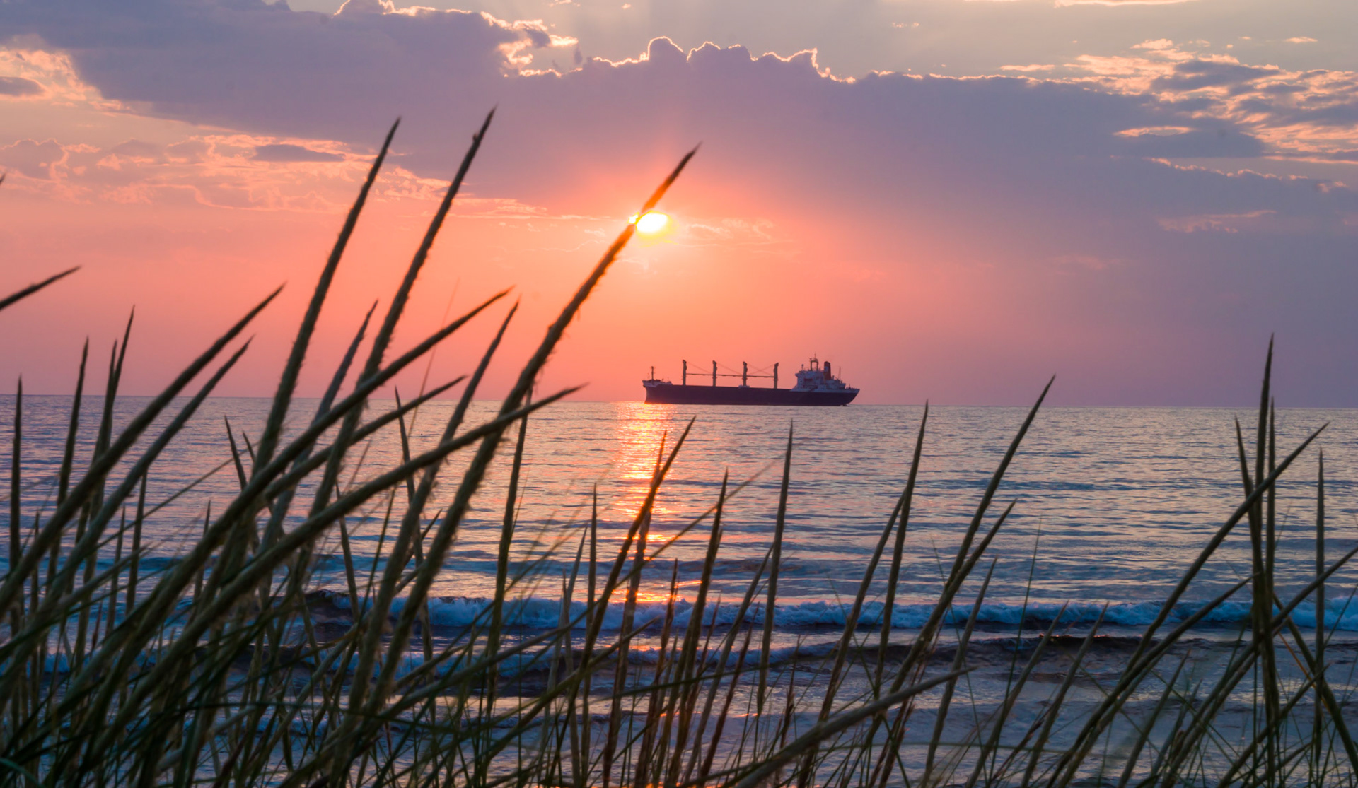 August 24th - Beach Grass and Sunrises - The light of a breaking sunrise over Lake Superior backlights a freighter as it waits at anchor. This image, taken on a quiet August morning along Park Point Beach, captured God's creation and points to His Glory.He is like the light of morning at sunrise on a cloudless morning,like the brightness after rain that brings grass from the earth. Samuel-2 23:4Calmness comes from the heart in knowing God and His providence in everything.