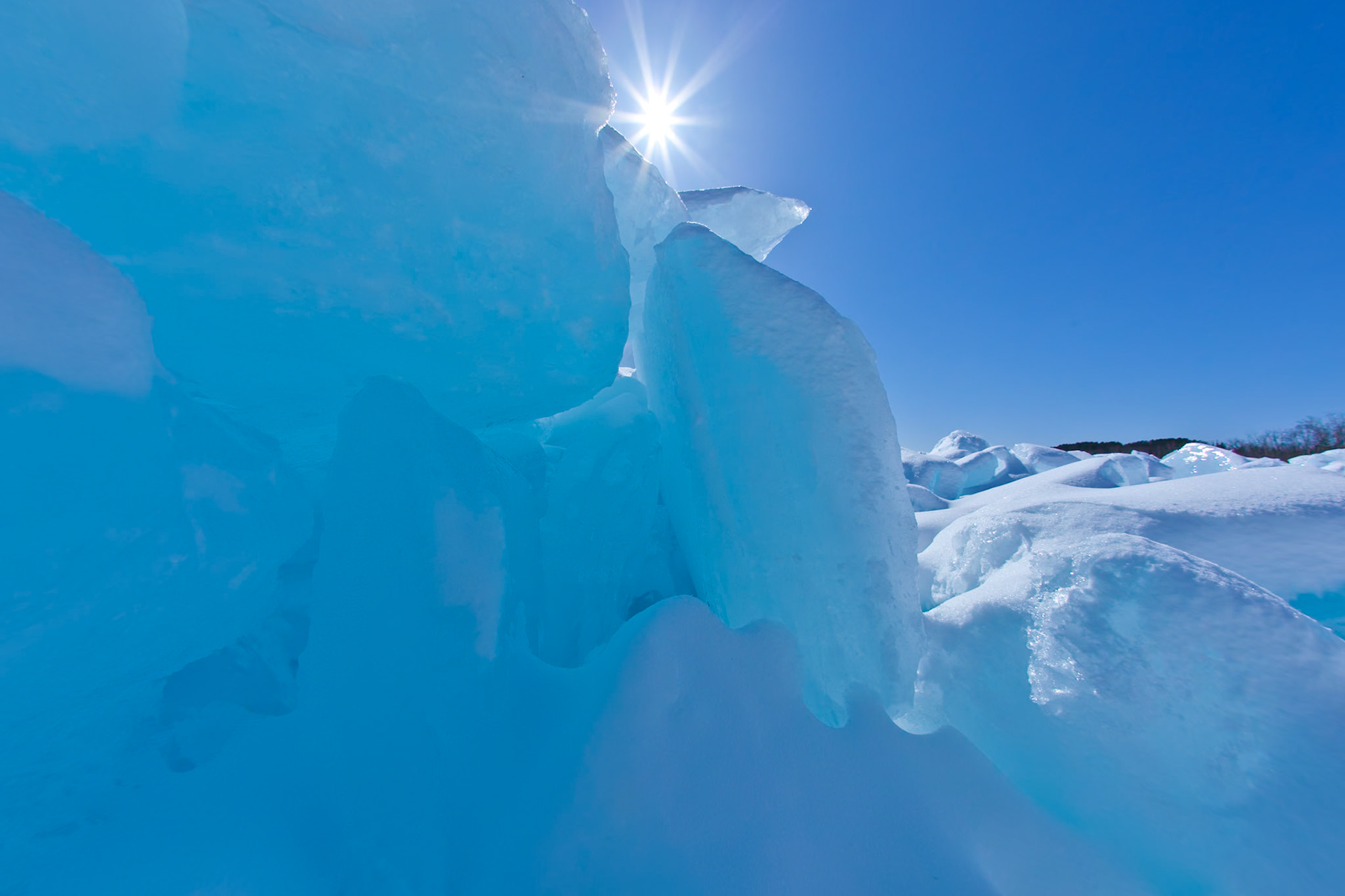 March 15 - Ice CoastMarch brings fabulous blue ice to the North Shore of Lake Superior. The blue skies of early Spring contrasted with the pure white ice along the shore of Lake Superior is a sight to behold.By the breath of God, ice is given, and the broad waters are frozen fast. Job 37:10It is incredible how a breath of fresh air seems to break the monotony of winter and raise the future's hope.