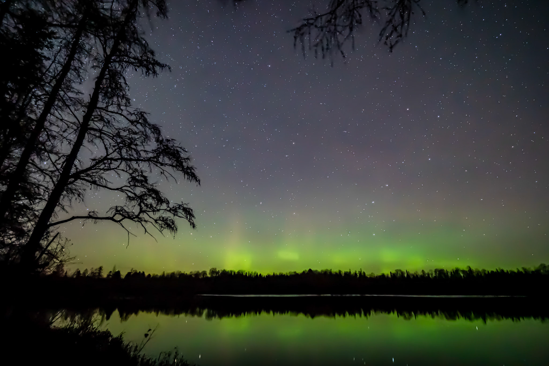 October 28 - Aurora GlowStars shine through the Northern Lights on a warm October night as they reflect onto the calm waters of a northern lake.The lights are easy to see with the longer night of October, even during early evening hours.With the calm winds, you can hear the melody of the local wolf pack howling to listen to the echo on the distant ridges.And God said, “Let there be lights in the expanse of the heavens to separate the day from the night. And let them be for signs and for seasons, and for days and years, Genesis 1:14