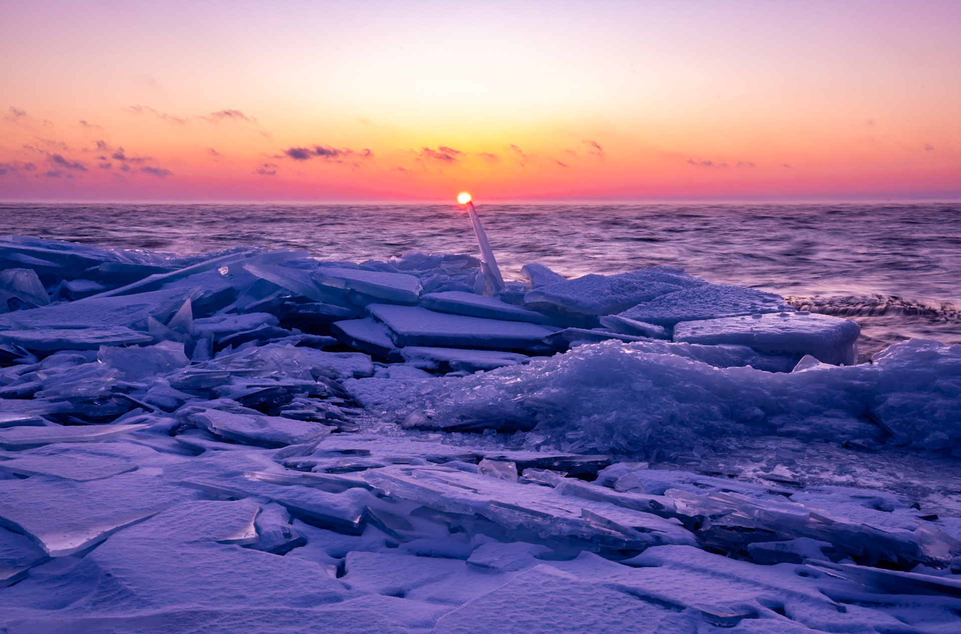 February 25 - Icy SunriseSunrise is breaking over sheet ice on the North Shore, with waves rapidly breaking the surface ice on Lake Superior. The sound of ice sheets moving against each other is like crystals swirling in a saucer.Heavy ice sheets stack on top of each other because ice is less dense than liquid water, allowing it to float. When wind, waves, or currents push floating ice against other sheets, the leading edge doesn't easily sink; instead, it redirects the force upward, causing one sheet to pile onto another like a slow-moving conveyor belt.The warm sunrise, clear air, and the fresh breeze are a good indication that Springtime is on the way.And God said, "Let there be lights in the expanse of the heavens to separate the day from the night. And let them be for signs and seasons, and days and years." Genesis 1:14The view of our natural world is like a veil through which God reveals who he is. He put it there for our pleasure and His glory.
