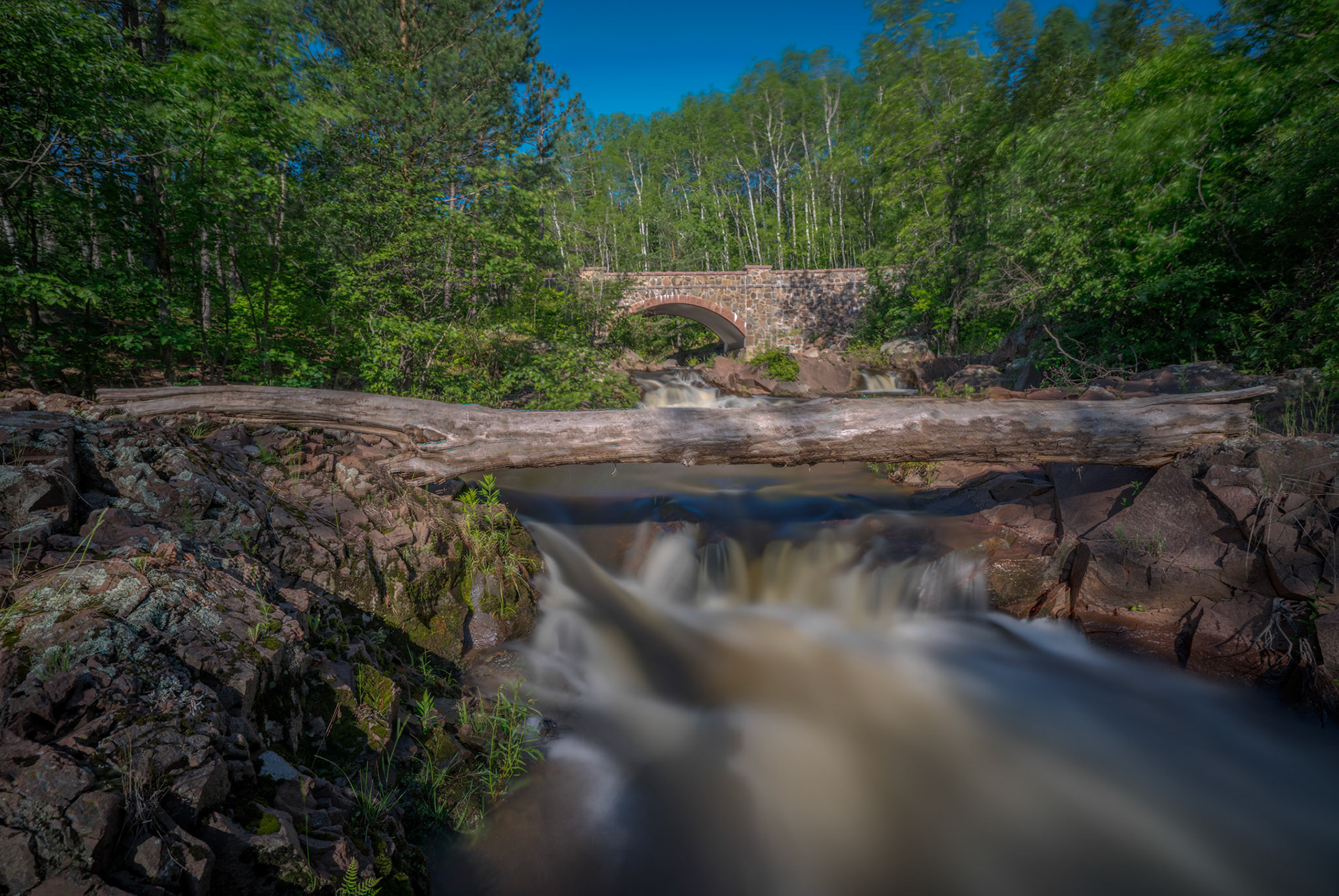 July 6—Amity Creek—Mid-summer rainfall rushes down Amity Creek on the far eastern side of Duluth.The stone bridge is one of the beautiful bridges built along Seven Bridges Road in 1900. It is part of Occidental Boulevard, which extends to Skyline Parkway.Seven Bridges Road is one of the hidden gems found in Duluth.He sends forth springs in the valleys;They flow between the mountains; Psalm 104:10