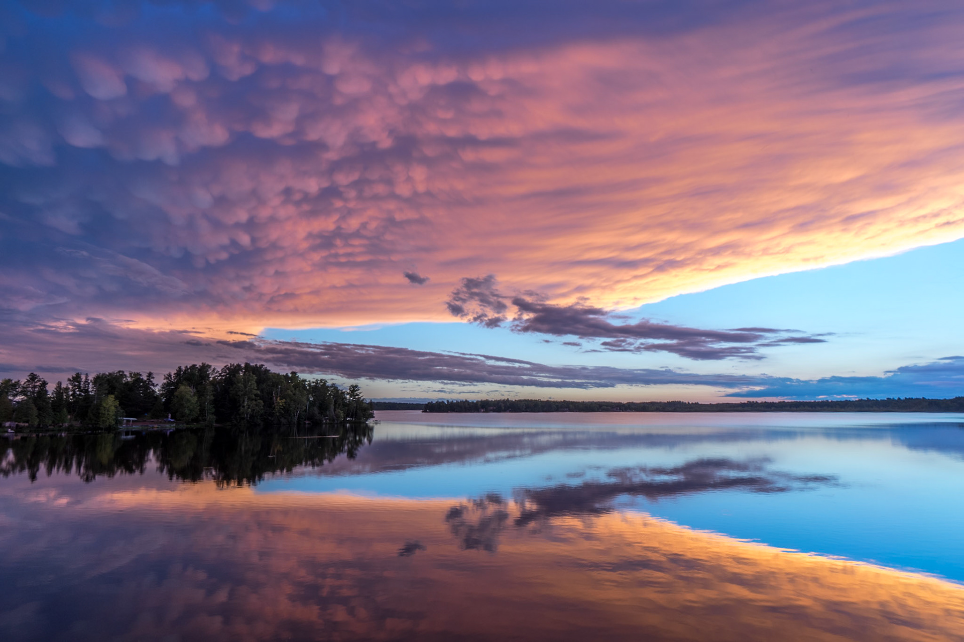 September 3 - Clouds in the WaterHeavy Thunderstorms swept south of Caribou Lake, leaving a beautiful sunset in its path. Reflections into calm water doubled the enjoyment of the scene.One Bible verse about reflection is from 1 Corinthians 13:12: "For now, we see only a reflection as in a mirror; then we shall see face to face. Now I know in part; then I shall know fully, even as I am fully known." This verse speaks about our current limited understanding and perception, which will one day be replaced by a complete and full understanding.God created the natural world to reveal Himself to us in all his various attributes.