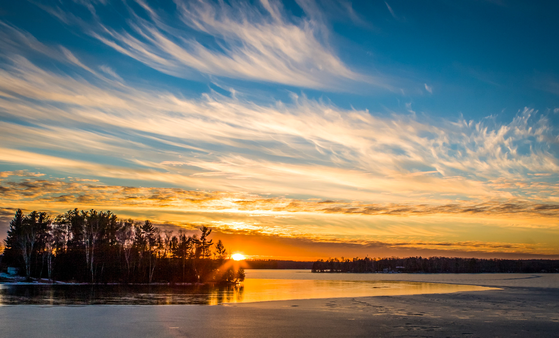 November 20 - Winter Wisps - The soft light of a cold November day fades into the distant horizon as winter's ice slowly grows across Caribou Lake.Consider the clouds, how they move across the sky, guided by the wind and shaped by the hand of the Creator. Just as the clouds journey through the heavens, so does the Lord's grace encompass all who seek refuge in Him."Do you know how the clouds hang poised, those wonders of him who is perfect in knowledge?"  Job 37:16
