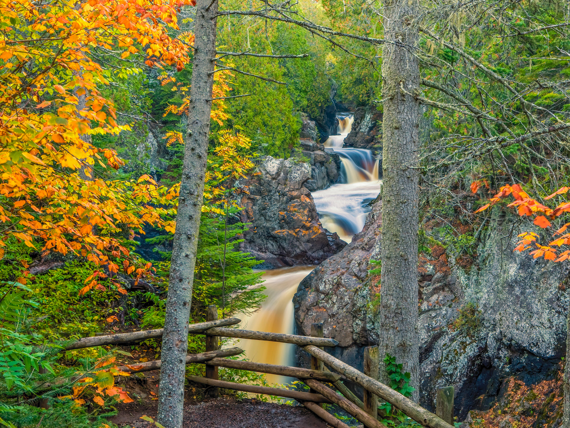 September 25—Cascading through Autumn—Recent rains swelled the rivers and streams along the North Shore of Lake Superior, creating magnificent scenes such as the upper Cascade River, where this image was taken. The sound of the turbulent waters below, combined with the autumn colors and sweet scent of the pines, fills the senses with God's created beauty.The Provision of GodAnd the Lord will guide you continually and satisfy your desire in scorched places and make your bones strong; and you shall be like a watered garden, like a spring of water, whose waters do not fail. Isaiah 58:11