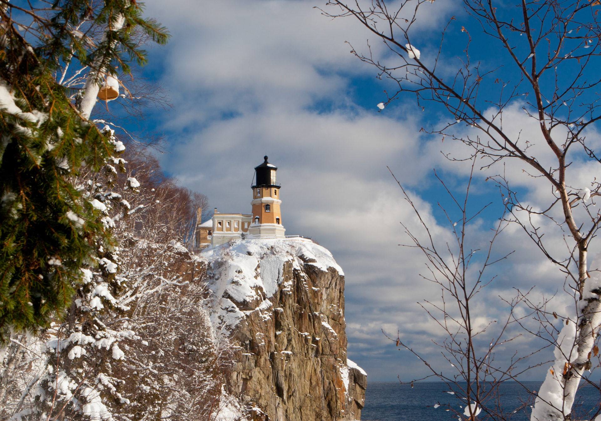 December 26th - White Light - Split Rock LighthouseFresh snow at Split Rock Lighthouse covers the landscape in a blanket of white.He gives snow like wool; he scatters hoarfrost like ashes. Psalm 147:16