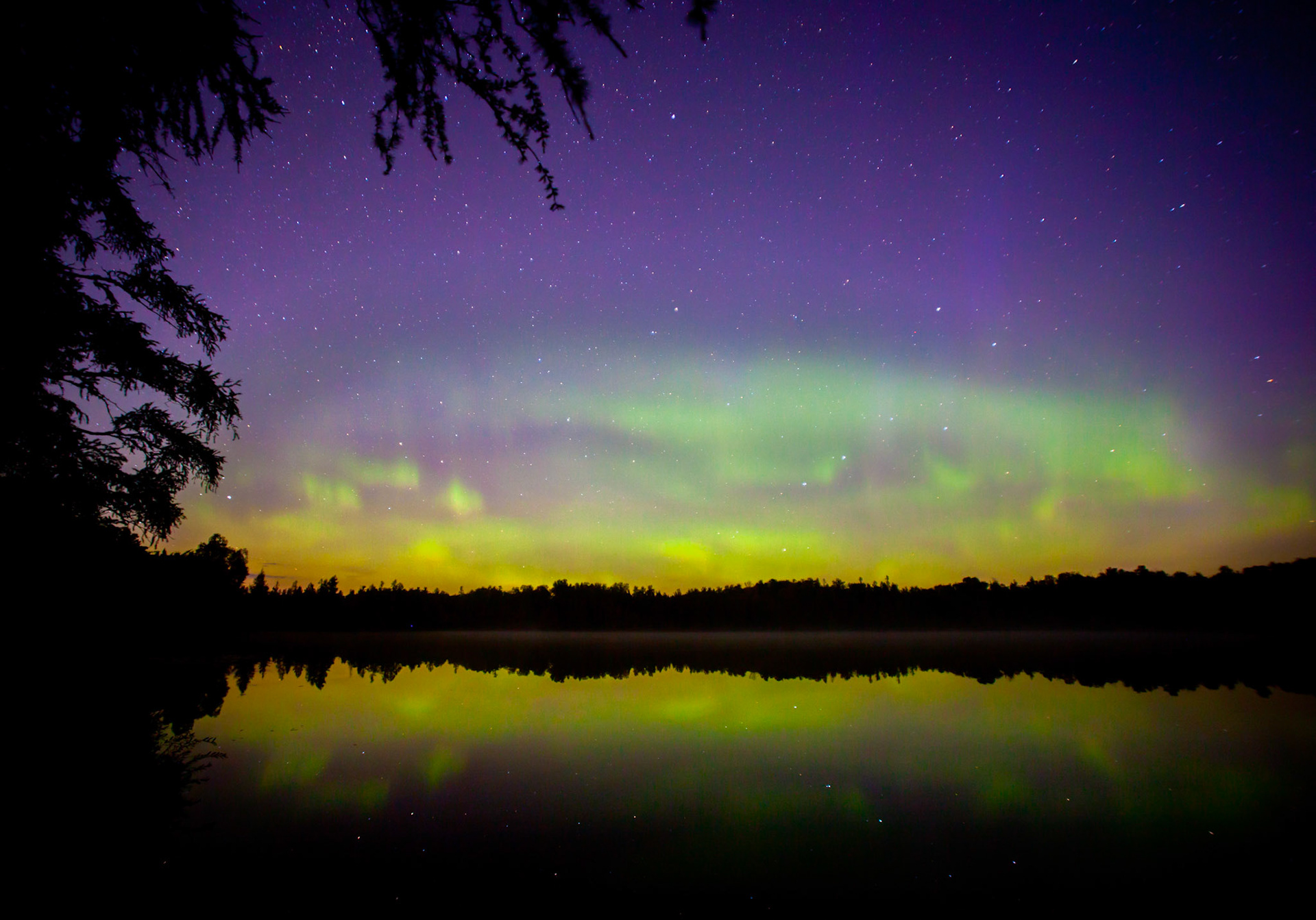 October 22 - Starry, Starry Night Stars shine through the Northern Lights on a calm October night.The flowing auroras and twinkling stars combine with the Big Dipper at center stage for a mesmerizing scene. At the same time, the Calm waters of Little Caribou Lake reflect the heavens while a local pack of wolves harmonized their choir to howl a melody to our creator.When I look at your heavens, the work of your fingers,    the moon, and the stars, which you have set in place,what is man that you are mindful of him,    and the son of man that you care for him? Psalm 8