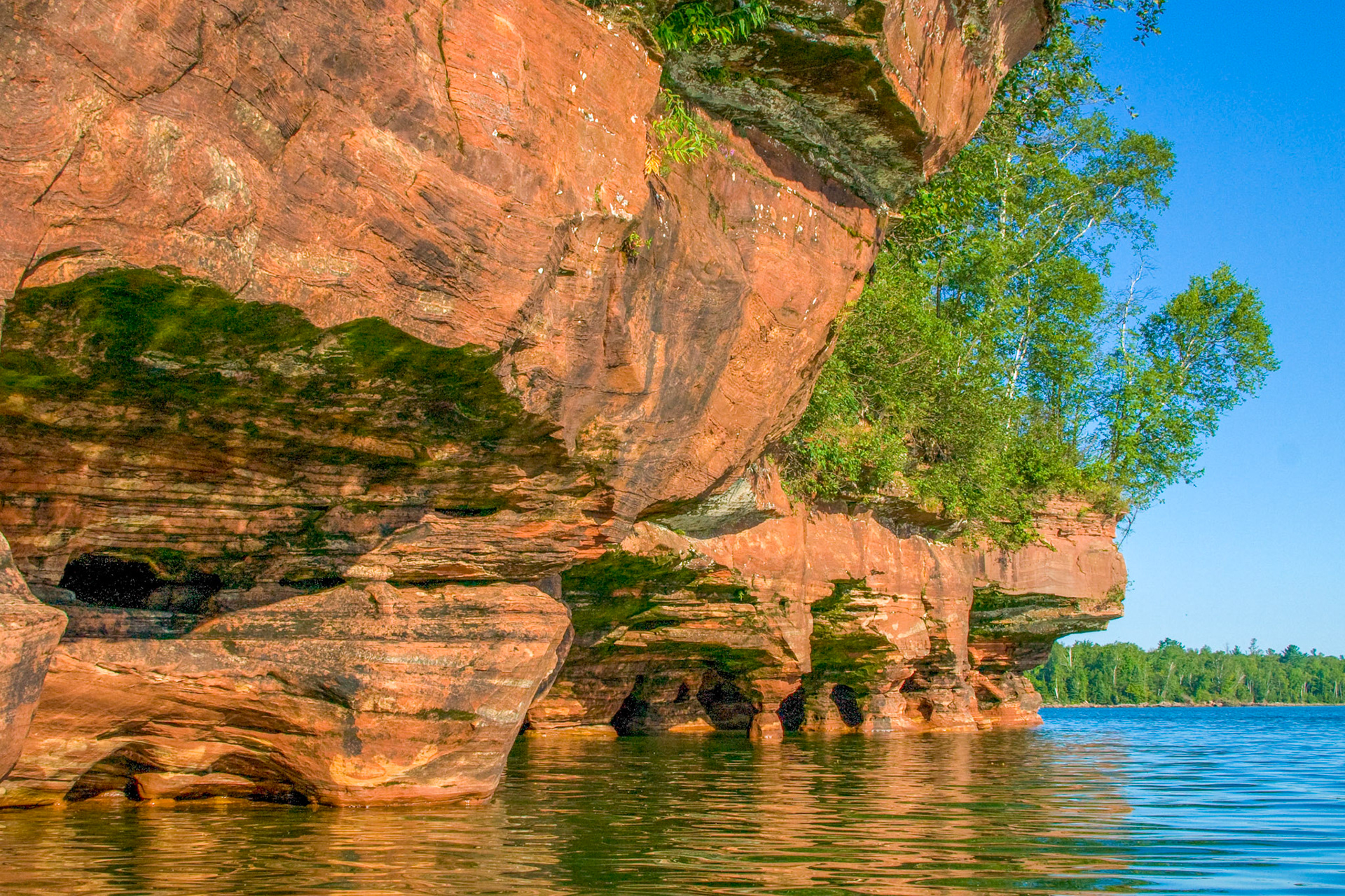 August 26—The Apostle Islands sit just offshore from the Bayfield Peninsula on Lake Superior. Sandstone erosion has carved out sea caves, which can be visited by boat during the summer and by air during colder winters. The caves are one of the region's wonders and give new meaning to "Heaven on Earth.""Trust in the Lord forever,For in God the Lord, we have an everlasting Rock. Isaiah 26:4