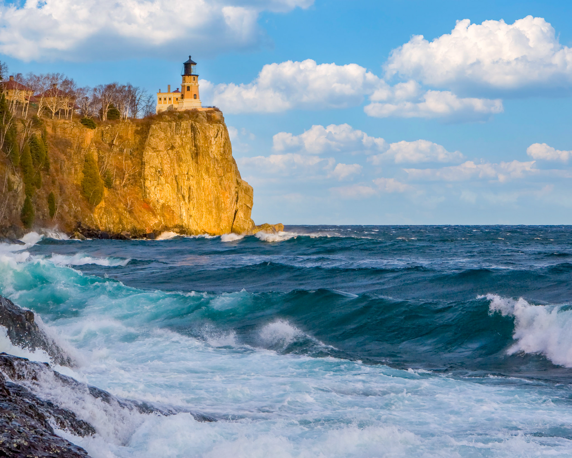 October 29 - Blue Waves at Split RockIt was a chilly and sunny afternoon at Split Rock Lighthouse on the shore of Lake Superior. The waves crashed against the rocks, creating a soothing sound that blended with the gentle breeze. The lighthouse stood high on the rocky cliff, the same as it had for more than 115 years. It was a peaceful and serene moment that made me feel grateful for the beauty of nature and joy to behold such beauty.As I stood there, Psalm 93:4 came to mind, saying, "Mightier than the thunder of the great waters, mightier than the breakers of the sea--the Lord on high is mighty." This verse reminded me of God's power and majesty, who created the vast and beautiful Lake Superior and all of nature's wonders. It was a humbling and awe-inspiring moment, and I felt blessed to witness it.