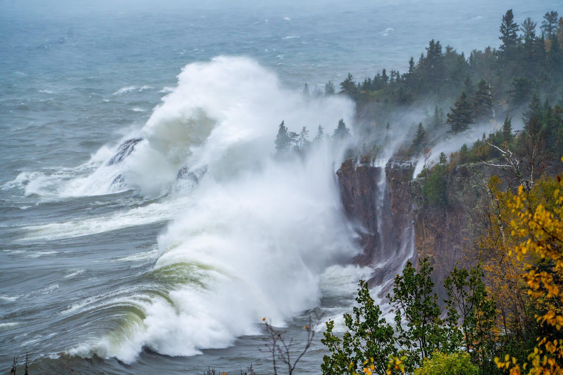 October 19 - Wave PowerA late October storm lashes out at the rocky cliffs along the Shore of Lake Superior. Crystal Bay near Silver Bay is a great location to observe the incredible power of the waves along Lake Superior. During this storm, you could hear the beach stones rolling in the waves along the shoreline and feel the vibration of the huge waves as they pounded the rocky shoreline.Watching the powerful blast of power against the cliffs is a humbling reminder of the elements in the hand of God.May you be strengthened with all power, according to his glorious might, for all endurance and patience with joy.; Colossians 1:11