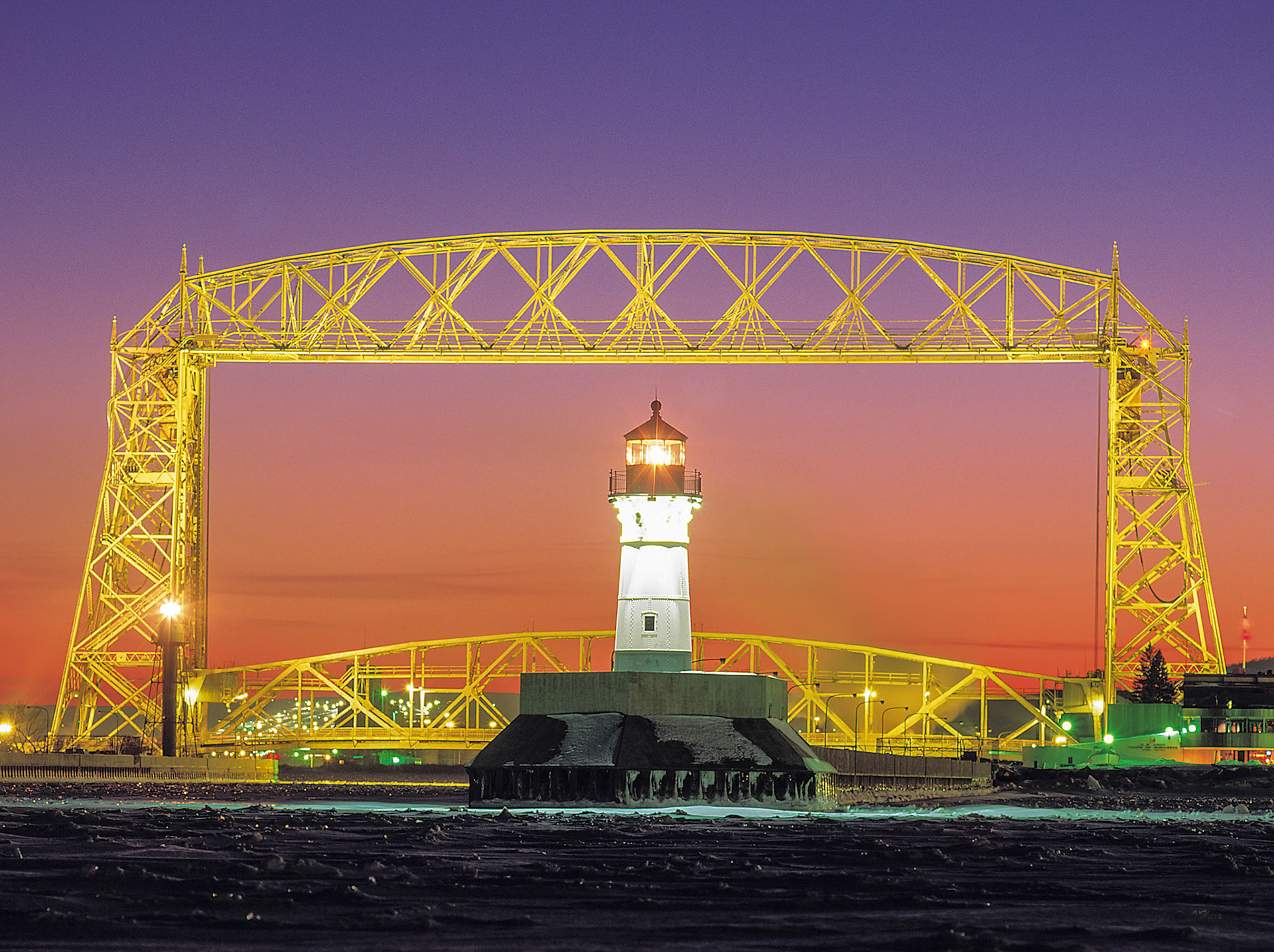 December 24th - Safe HarborThe Lift Bridge frames the Duluth North Pier Lighthouse on a frigid December night.Send out your light and your truth; let them lead me; let them bring me to your holy hill and to your dwelling! Psalm 43:3