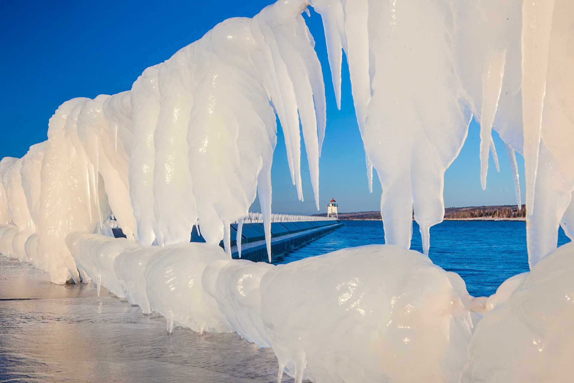 February 14 — Ice FrameBy mid-February, stronger weather systems roll into the Lake Superior region, bringing powerful winter storms. As waves crash against the shoreline, they sculpt magnificent ice formations along the big lake’s edge — natural works of art that invite you to come witness them in person.The breakwall in Two Harbors is one of the best places to photograph these displays after a storm. If you carefully walk along the icy surface, you will be rewarded with a front-row view of a transformed landscape. Step out and let the crisp air refresh your senses — making the experience truly unforgettable.Photography is a wonderful reason to get outside this time of year — whether you’re carrying a professional camera or just using your phone. Invite a friend, bring your family, or simply treat yourself to a creative outing. You aren’t just capturing an image; you’re preserving a memory to cherish for years. This photograph was taken 15 years ago, yet I remember standing there as if it were yesterday.“Your word is a lamp to my feet and a light to my path.” — Psalm 119:105Christ walks with you—even when your footing feels unsure—and the Bible remains your steady guide, illuminating every step you take, no matter how dark or uncertain the journey may seem.