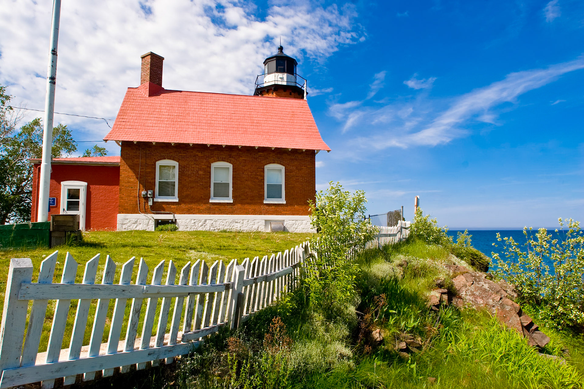 May 24 - Eagle Harbor LighthouseThe red brick Eagle Harbor Light Station sits on the rocky entrance to the harbor and is a working lighthouse as it guides mariners across the northern edge of the Keweenaw Peninsula.