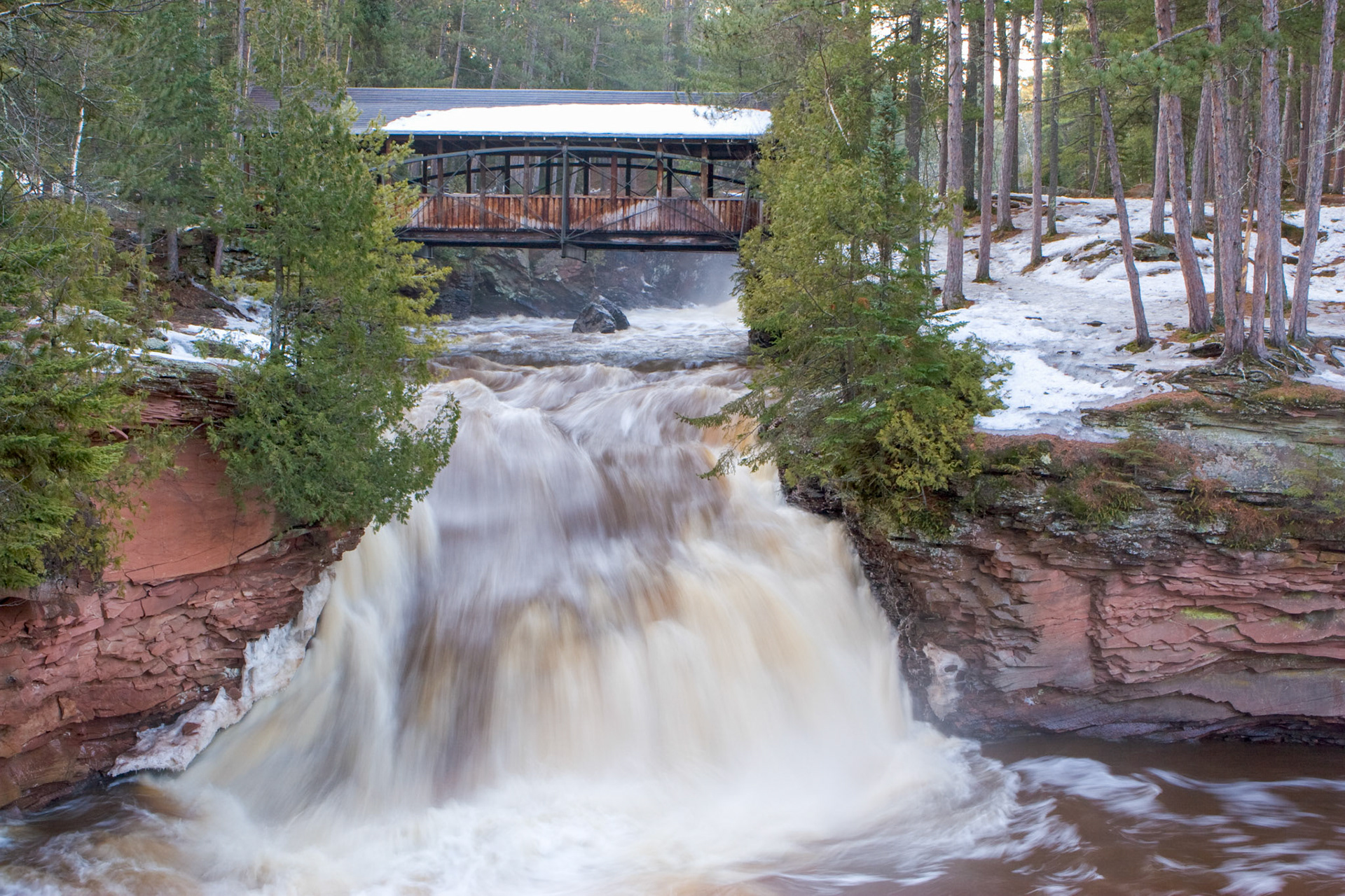 April 2 - Springtime in the ForestThe Amnicon River, flowing through Amnicon State Park south of Superior, Wisconsin, is rushing with melting snow from the inland snowpack.The Horton Bridge in Amnicon State Park is a historic landmark on the National Register of Historic Places. This picturesque bridge spans the Amnicon River and offers stunning views of the surrounding forest. It is also called a Bowstring bridge and a popular spot for photographers and nature enthusiasts. And I heard a voice from heaven, like the sound of many waters and like the sound of loud thunder, and the voice which I heard was like the sound of harpists playing on their harps. Revelation 14:2The sweet smell of the pine needles covering the forest floor was overpowering, as were the sounds of the birds and the rush of water. Go for a walk today if you can; it will be a wake-up call to enjoy God's creation.