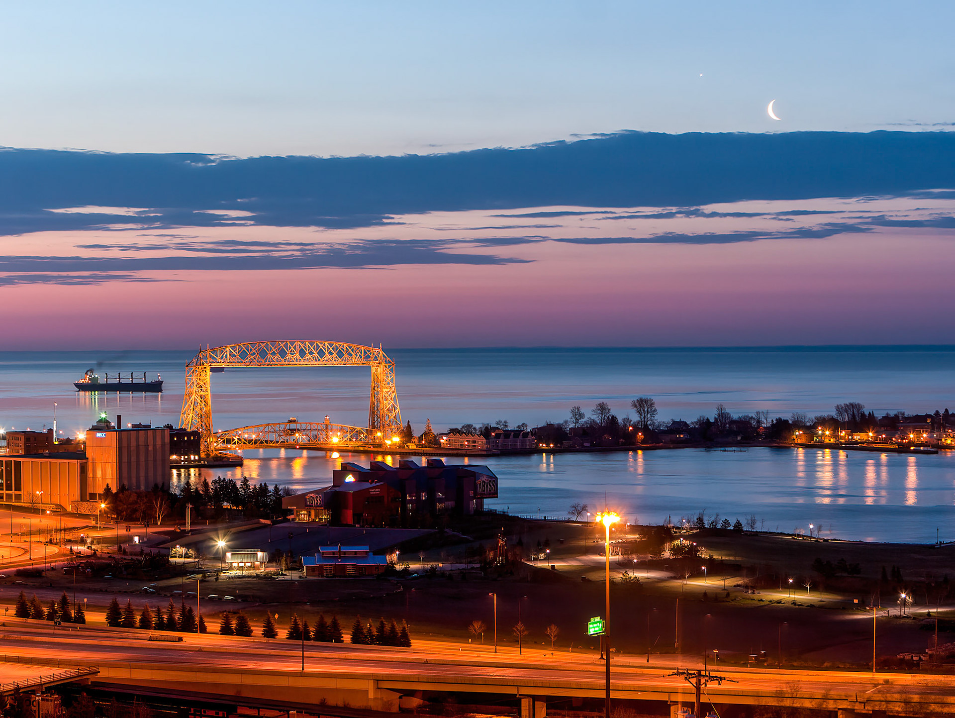 April 1 - Crescent CityA crescent moon quietly glows over the city of Duluth, where only a few residents are awake to enjoy it. Daylight hours now surpass night, and winter is giving up its strength to the incoming season.The hour just before sunrise is a magical time of day for photography. It is an excellent time for photographers to capture stunning images using natural light. Saturated colors magnify the beauty of creations, and calm winds add to the effect.When I look at your heavens, the work of your fingers,    the moon and the stars, which you have set in place,Four what is man that you are mindful of him,    and the son of man that you care for him? Psalm 8Each day is a gift from the One who made all things!