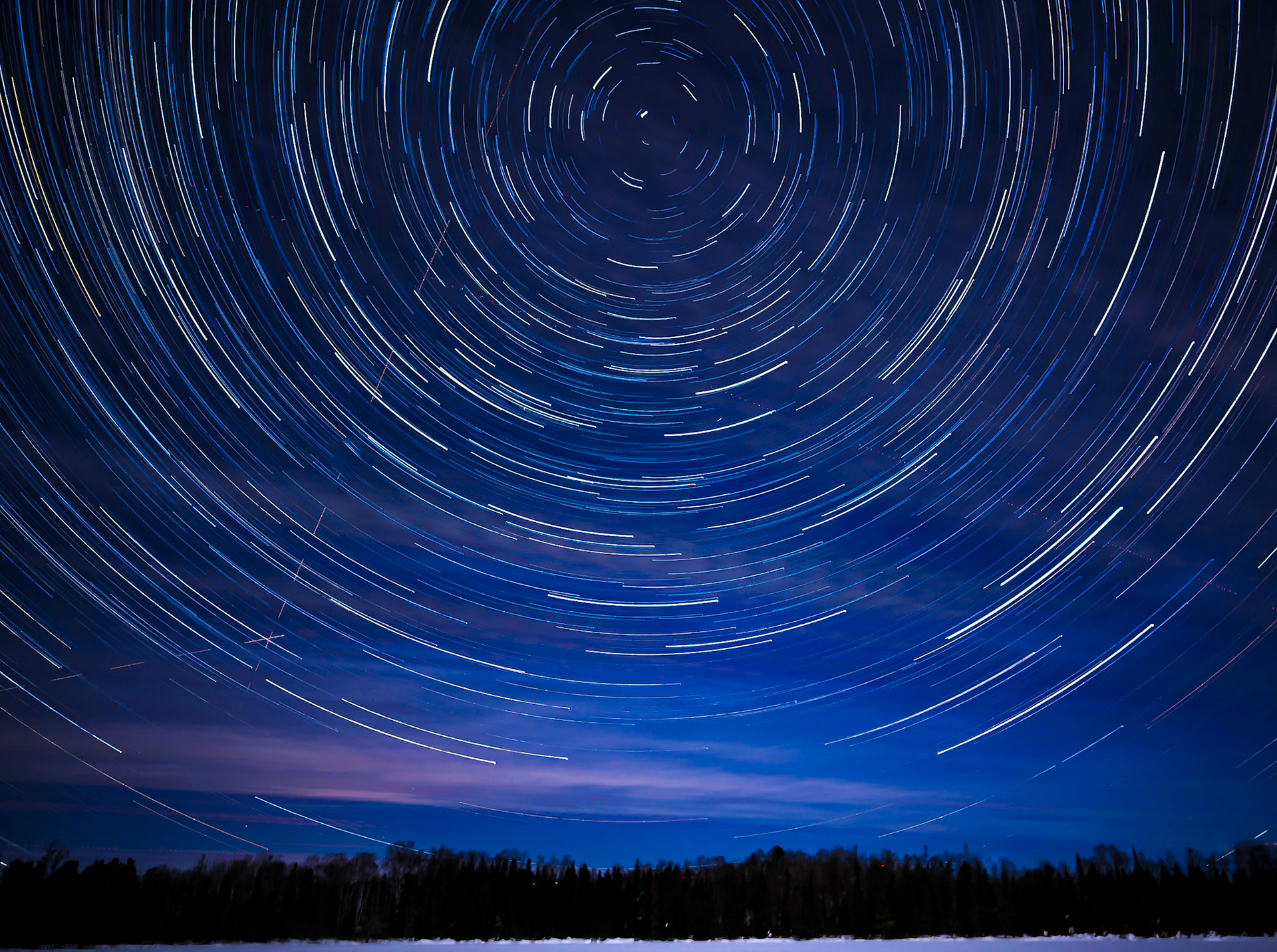 March 4 - Spring Star TrailsStar trails are easy to photograph using a tripod and photo release cable. You set a manual exposure of 3 to 30 minutes, and you will have your star trails.In this image, I set up the camera looking north to capture the North Star (Polaris) as the stars rotate in a circle around it. It is the rotation of the earth that creates the appearance of the stars moving.The heavens proclaim the glory of God. The skies display his craftsmanship. Psalm 19:1It is a humbling experience to view our Master Creator's Work on full display in the night skies.