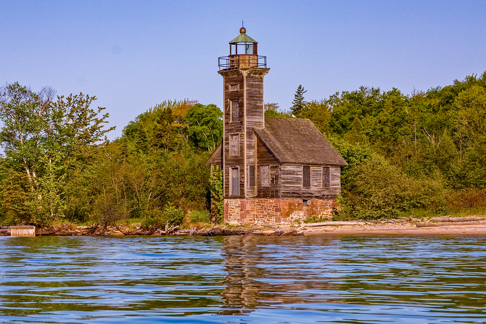 May 22 - Grand Island East Channel Lighthouse The small wooden frame lighthouse on the southeast shore of Grand Island was constructed during the period 1869-1870 for the the purpose of guiding vessels into Munising Harbor from the east. The land was one of a number of parcels reserved in 1847 for government use.