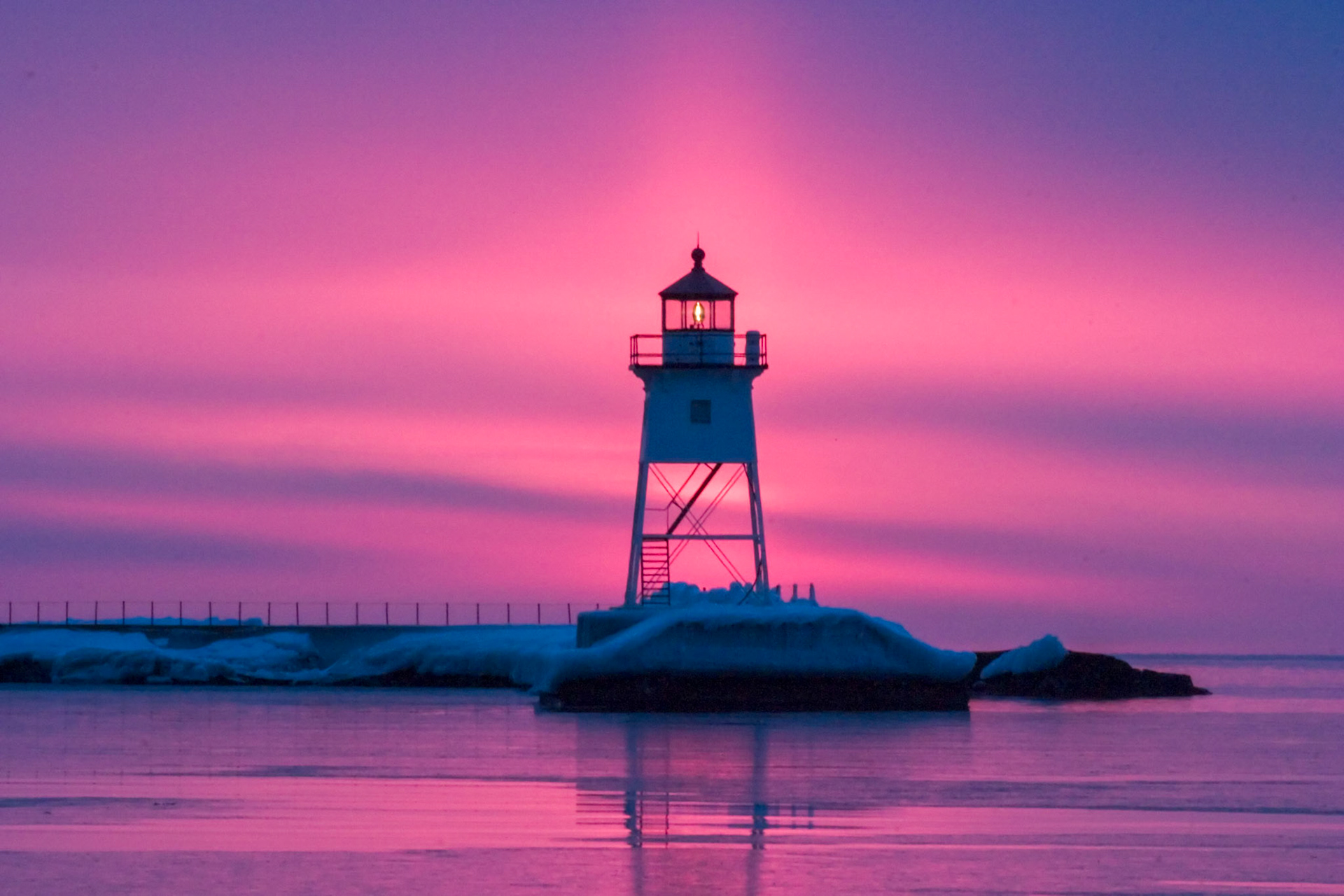 February 22 — Sun PillarRefracted LightThis stunning sun pillar formed behind the Grand Marais Lighthouse just after sunrise. Atmospheric conditions were perfectly aligned, allowing sunlight to refract into a breathtaking vertical beam.Tiny, flat ice crystals drifted through the air, acting like millions of miniature mirrors. When the Sun sits low on the horizon, these crystals reflect its light straight back to our eyes, creating the glowing column we call a sun pillar — even though no physical “pillar” of light actually exists.A cold, stiff breeze off Lake Superior reminded me that it was still February, but witnessing this rare scene made the discomfort worthwhile.“I form light and create darkness, I make well-being and calamity, I am the Lord, who does all these things.”— Isaiah 45:7Each day is a gift from God. Enjoy it, and take time to look around as you go about your day — even the smallest moments can remind us of His presence in creation.