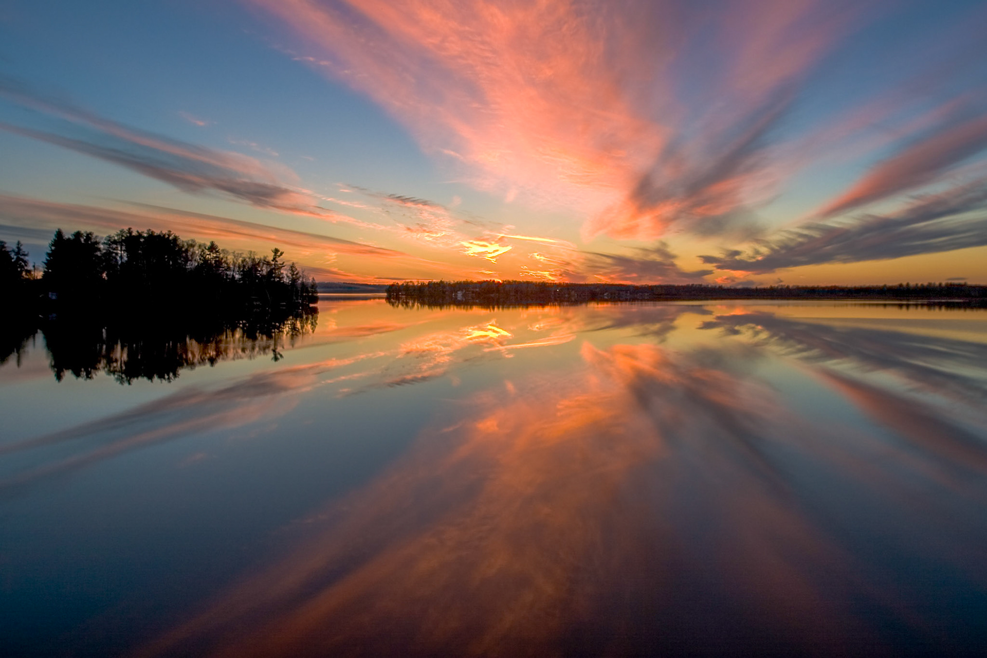 October 24th - Evening Reflection Evening clouds reflect into the waters of Caribou Lake.With colors fading across the northland, you can look to the sunrises and sunsets for brilliant, saturated colors. When reflected into calm waters, these colors double their beauty, creating a breathtaking sight.As in water, face reflects face, so the heart of man reflects the man. Proverbs 27:19