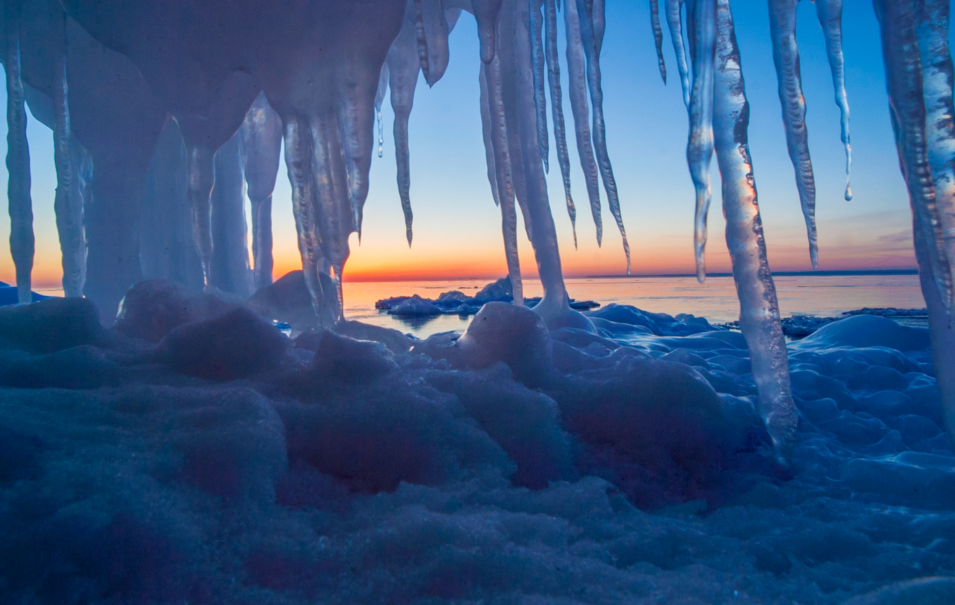 February 2 — Captured by WinterWalking the shoreline of Lake Superior in winter, you discover ice formations of every kind. For this image, I reached in and placed my camera beneath an ice shelf to capture the sunrise—a reminder of how different the world can look from a new perspective.Even in early February, the sun’s power is strong enough to form icicles on exposed rocks, creating striking and ever-changing shapes.One of the great gifts of photography is that no two days are ever the same. The season advances day by day and month by month, quietly blending into another year.“To every thing there is a season, and a time to every purpose under the heaven.” — Ecclesiastes 3:1Your life flows with the seasons. Each day is special and can never be repeated. Enjoy today — it is a gift.