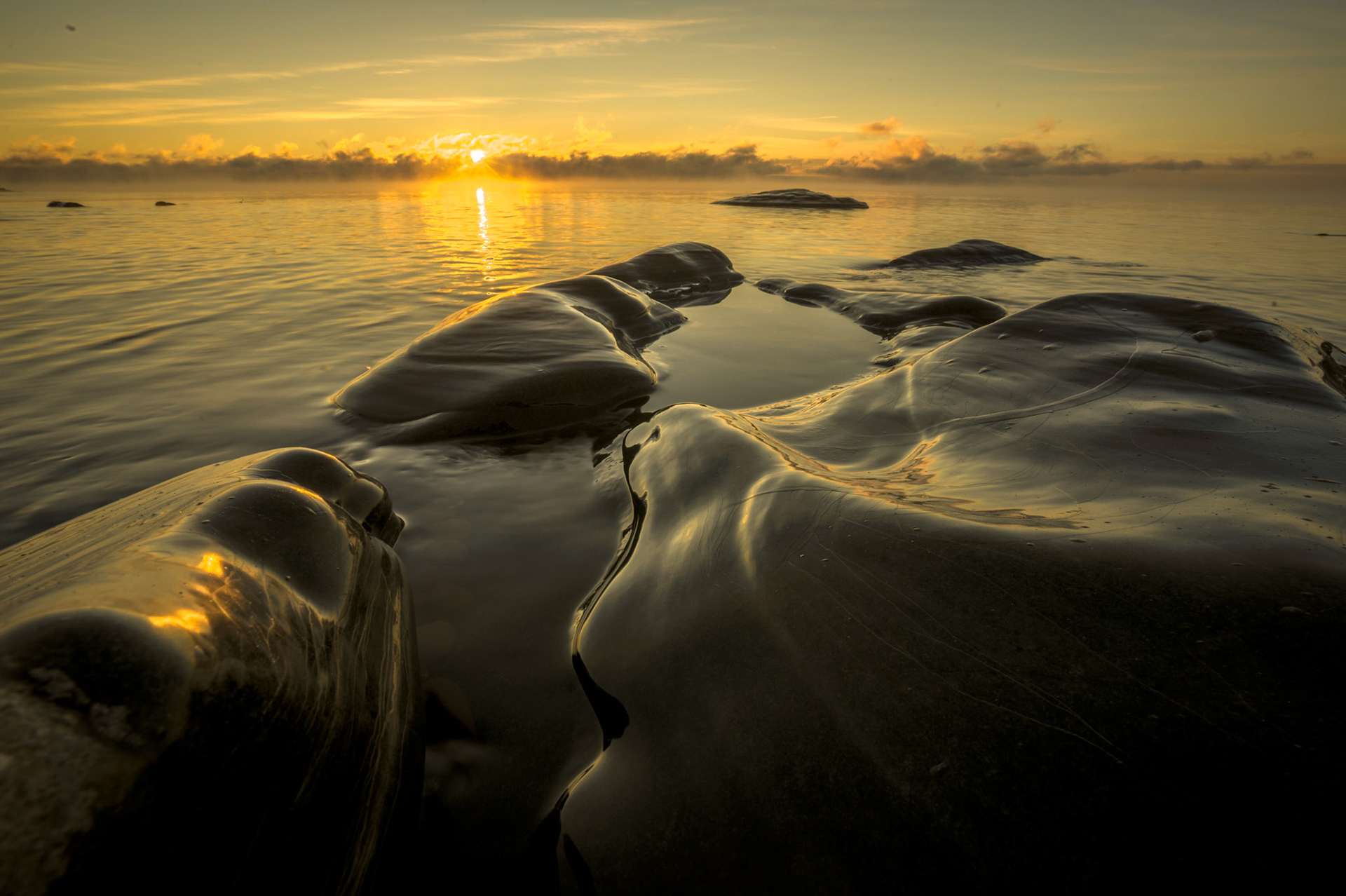 December 29 - Clear IceDeep Winter in the Northland brings a slumber on the landscape and rest to our soul. This scene along the North Shore of Lake Superior combines extreme cold with a warm sunrise. He causes the vapors to rise from the end of the earth; He makes lightning for the rain; He brings the wind out of His storehouses. Psa 135:7