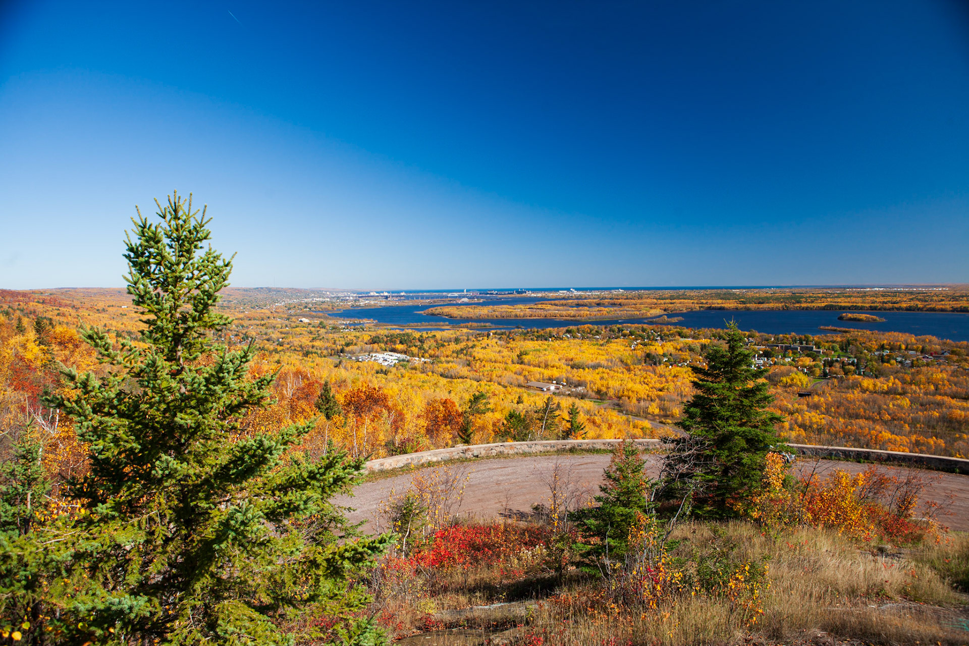 October 17 - Golden Landscape - The final color change of the landscape on the Duluth hillside is fully displayed as autumn sweeps through and begins its exit from the Northland. This scene from Barden's Peak along Skyline Drive captures the golden landscape's glory.Clear Canadian air has swept the area, offering a crystal clear view of the Northland from 800 feet up Skyline Drive.It just doesn't get much better than this, and it encourages me to get outside and enjoy autumn.Give thanks to the Lord, for he is good, for his steadfast love endures forever. Psalm 136:1