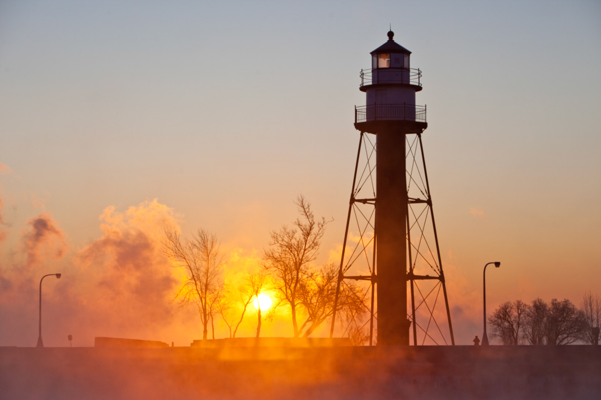 December 8th - December SunriseWith deep winter now settling into the Northland,  the steam off Lake Superior rises from the water and seems warm on -20F mornings. He has inscribed a circle on the face of the waters at the boundary between light and darkness. Job 26:10