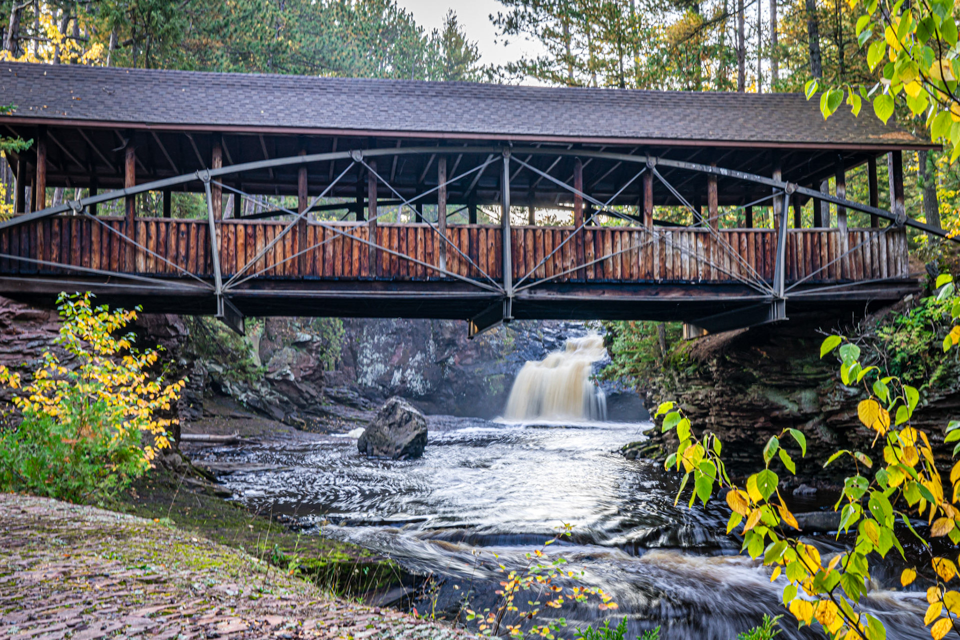September 28 - Bowstring Bridge - The 55-foot-long Bowstring Bridge at Amnicon Falls State Park spans the river at the Lower Falls. This unique bridge, also called Horton Bridge, was designed by Charles M. Horton in 1898. It originally had no roof and was a highway bridge located further upstream.Taking a stroll across this elegant bridge, combined with the sound of the river below and the scent of the cedar forest, makes a complete sensory delight any time of year.The setting for this bridge makes it a unique location filled with solitude and peace where one can escape the day's business and find a small piece of paradise.The peace of God!The LORD is my shepherd; I shall not want.He makes me lie down in green pastures.He leads me beside still waters. He restores my soul.He leads me in paths of righteousnessfor his name’s sake.Even though I walk through the valley of the shadow of death,I will fear no evil,for you are with me;your rod and your staff,they comfort me. Psalm 23